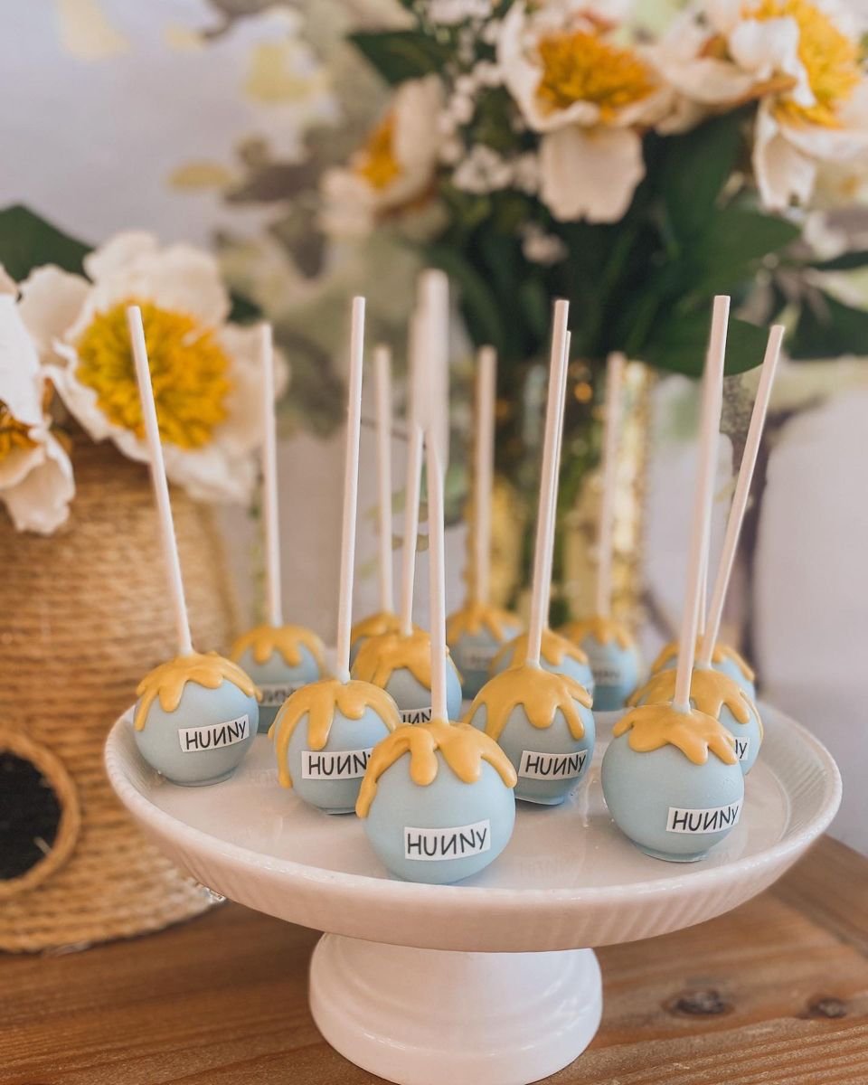 Pooh bear baby shower cake pops.jpg