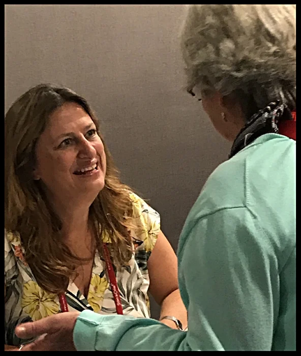 Elly Griffiths signing a book for a fan at Bouchercon 2018.jpg