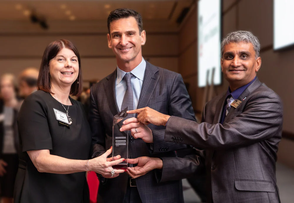 Jeff Aronin receives Northern Illinois University’s 2019 Innovation and Entrepreneurship Award, presented by Dr. Lisa Freeman, President of NIU, and Dr. Balaji Rajagopalan, Dean of the College of Business.