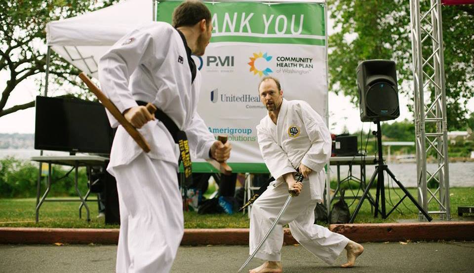 Bryan Rodriguez (left) doing a fight demo with sensei Greg Sommers-Herivel. 
