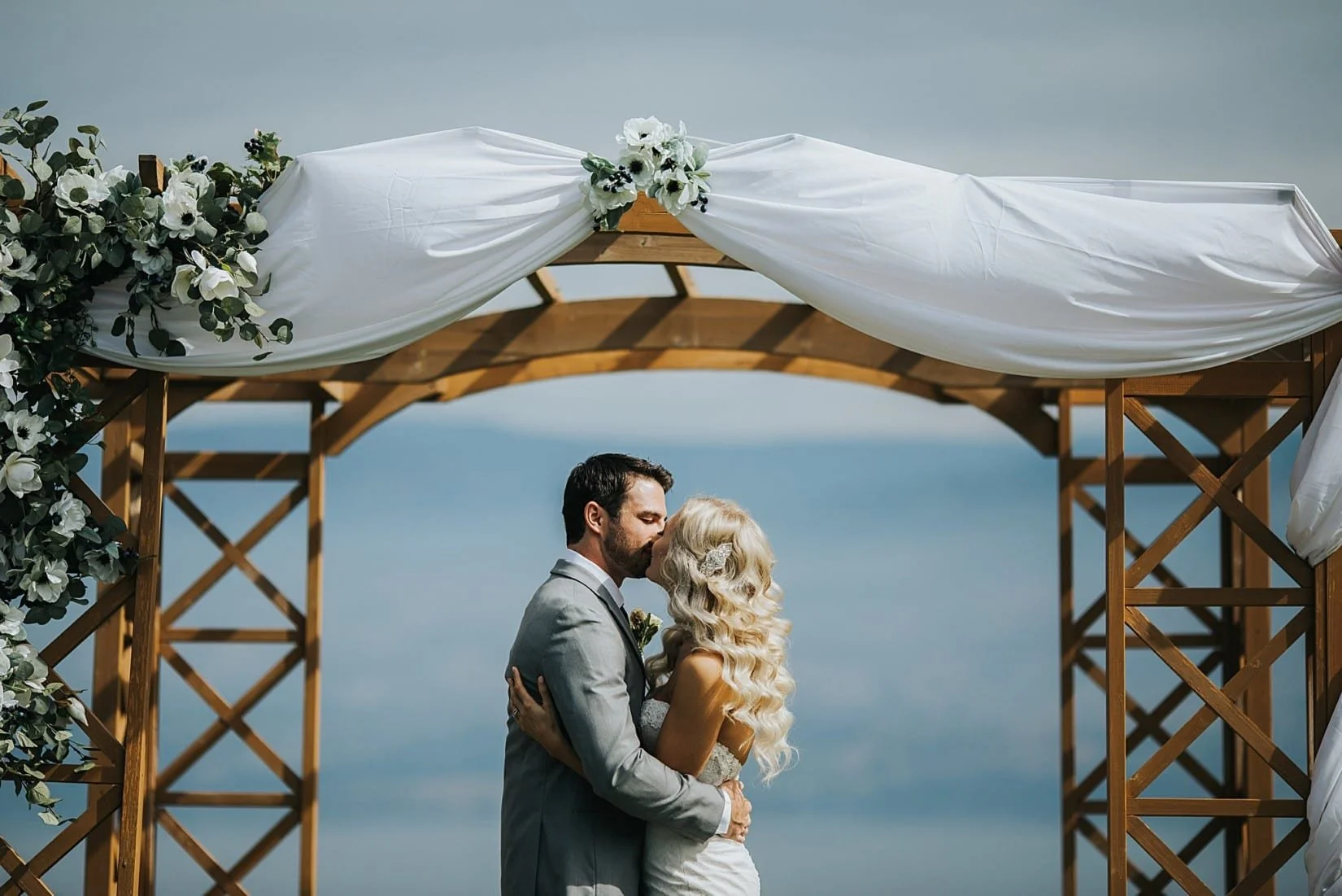 Couple Kissing at Wedding Stand