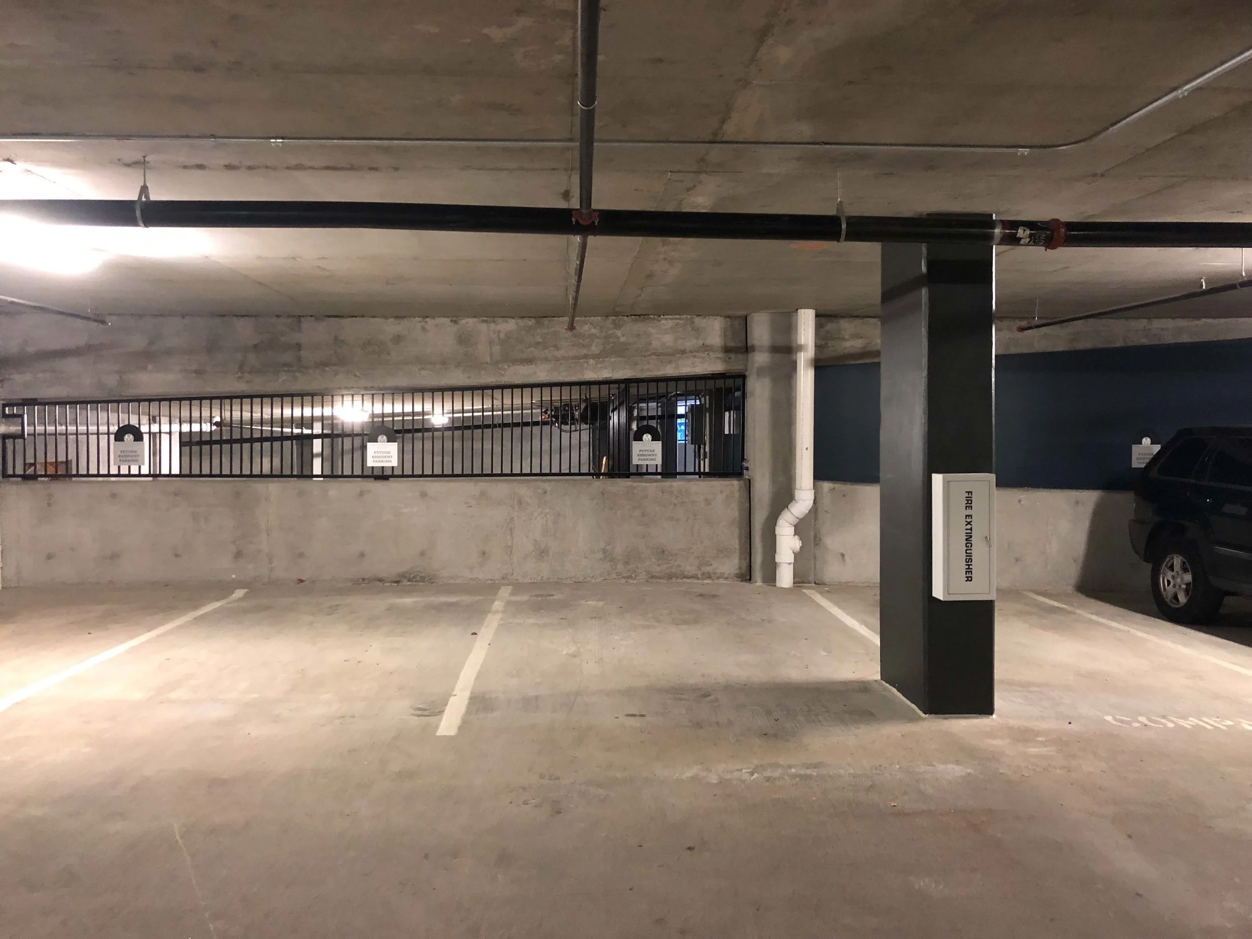 Locale parking are along the wall, on the incline heading up to the second floor.