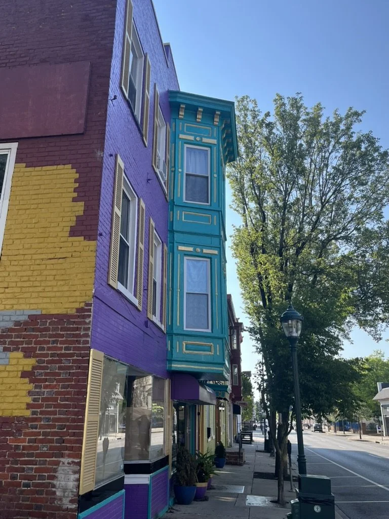 Brightly painted historic rowhouses on a downtown street in Hagerstown, Maryland