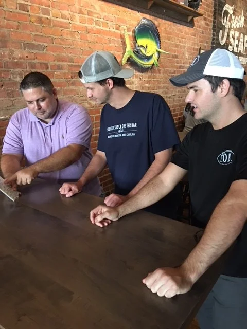 Barry (left) of the Wilmington Shuckin' Shack training Austin the GM and Darin (right) the Front of House manager for Statesboro.