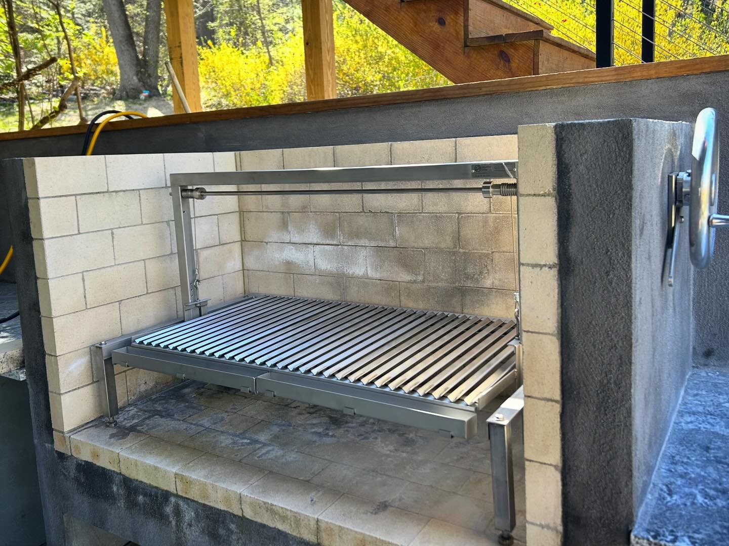 Here is a nice chimney-top installation for one of our large Clasico grill inserts. 

1. Just build the opening a little bit larger than your grill. 

2. Simply stand the grill inside the opening on the hearth floor. 

3. We will supply you with a cr