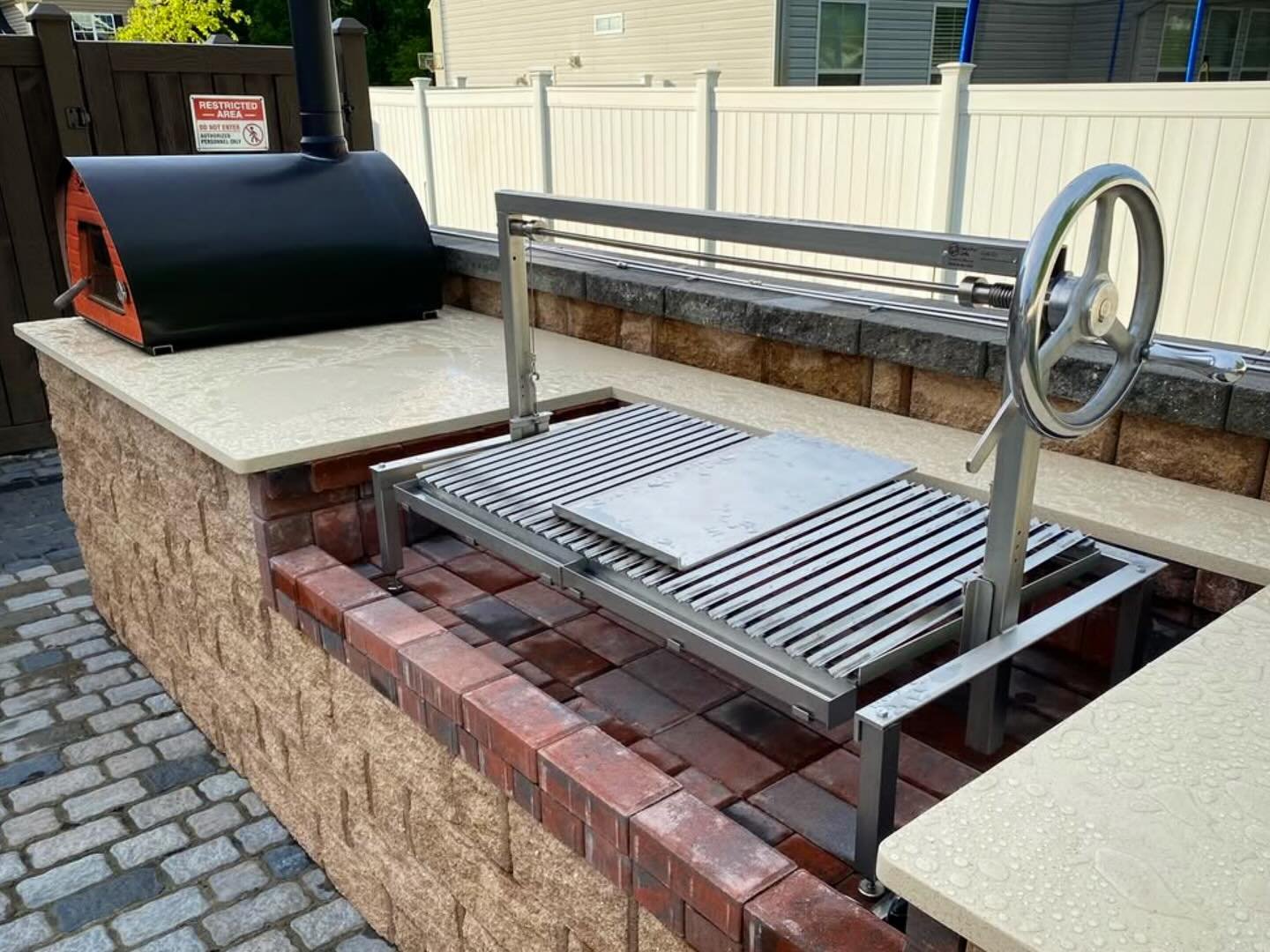 Large Clasico grill insert with plancha right at home next to the pizza oven.  Great pairing for an outdoor kitchen. 
.
.
.
#grilling #outdoorkitchen #madeintheusa #parrilla #outdoorliving #giftideas  #patio #backyard #firebrick #customgrill #woodfir