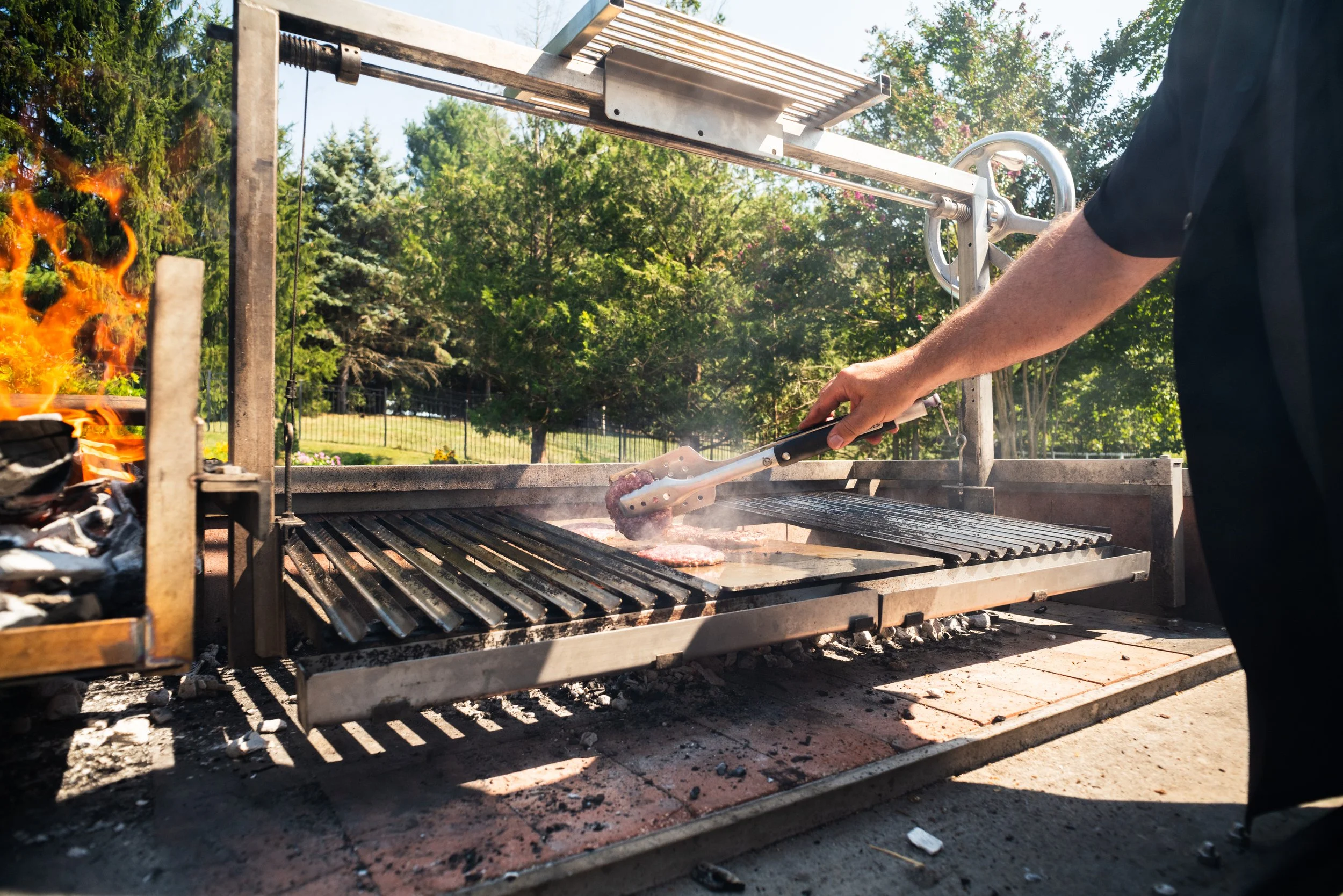 Argentine parrilla grill outdoor cooking with adjustable height grates