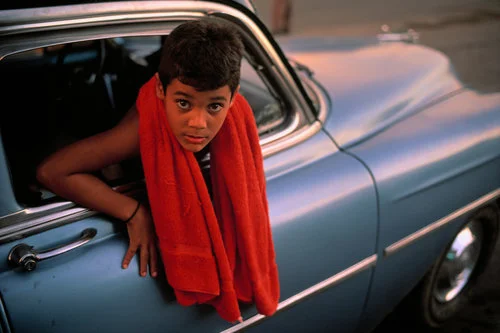 CUBA. Camaguey. 1998. A 9 year old boy in a 1953 Chevrolet.