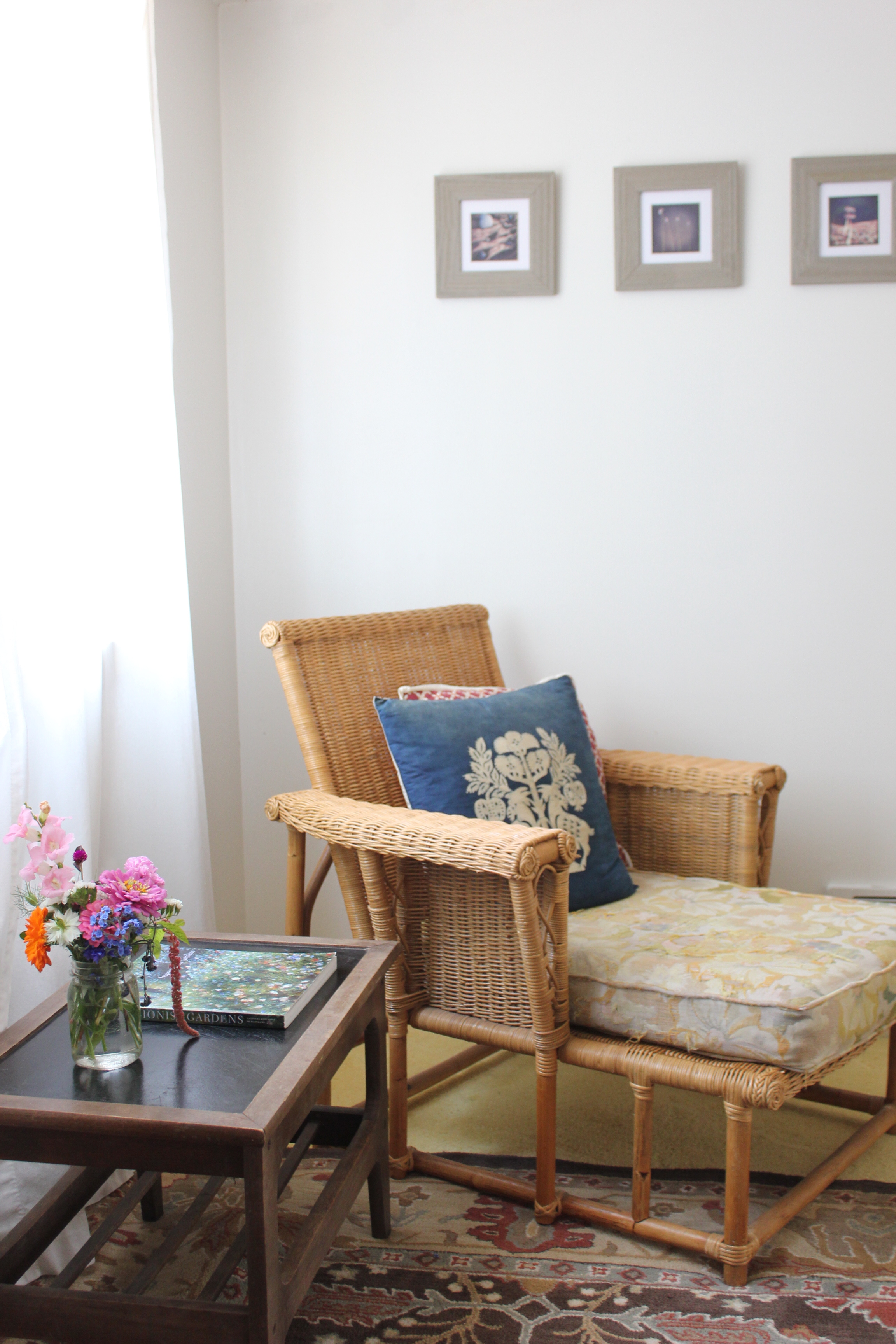 rattan recliner and fresh flowers at plum nelli farm chic airbnb.JPG