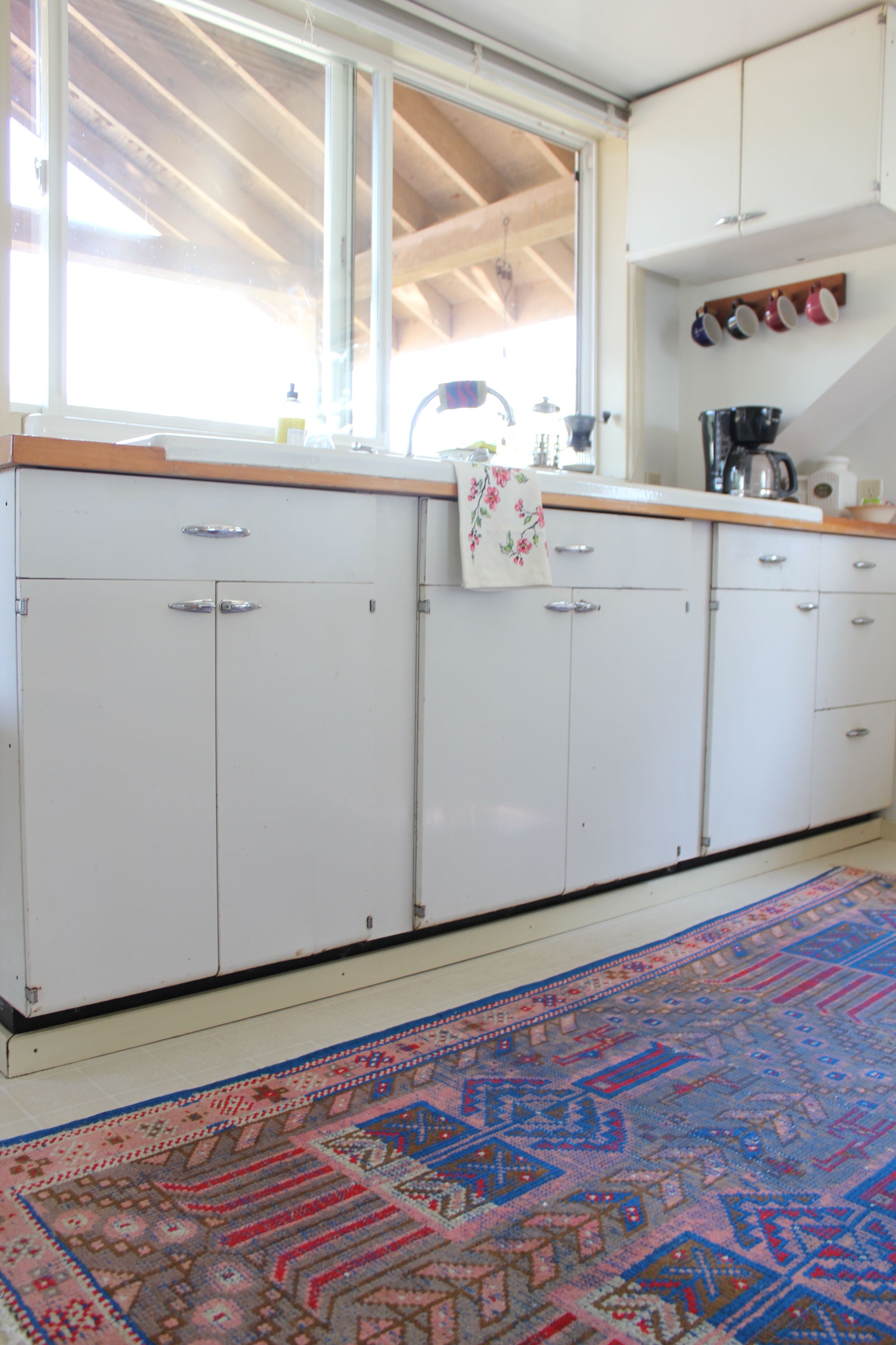 vintage cabinets and turkish rug in plum nelli washington farm home.JPG