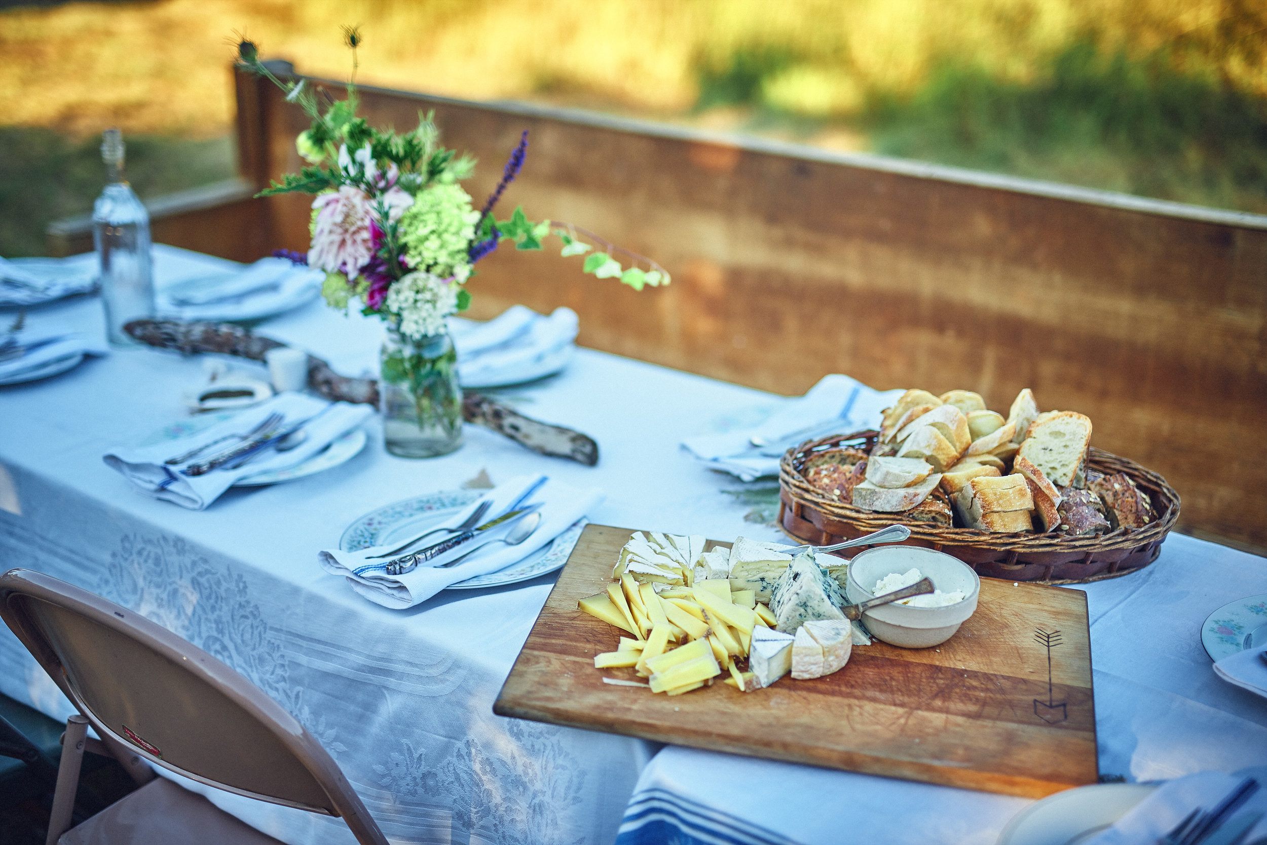 table setting bread and cheese church pew at plum nelli farm wedding.jpg