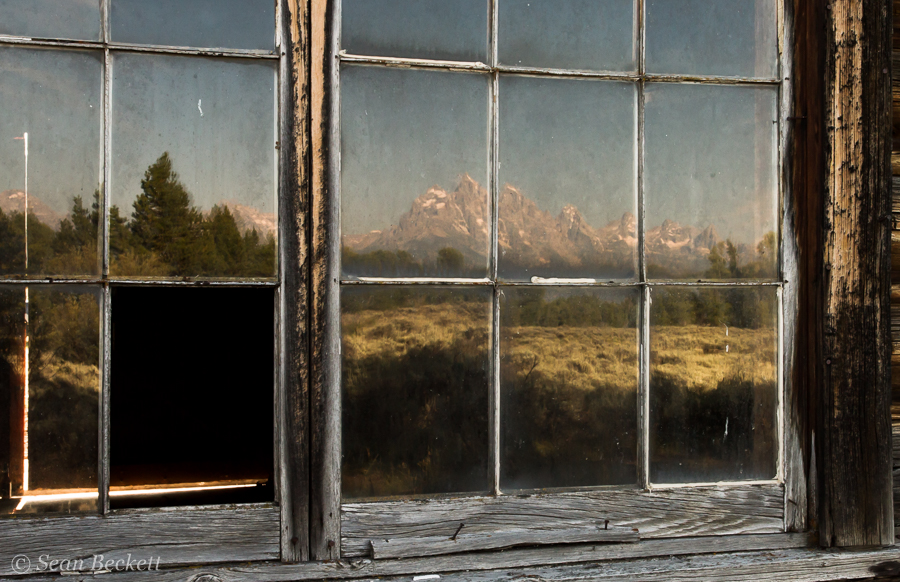 mountains reflected in old window panes