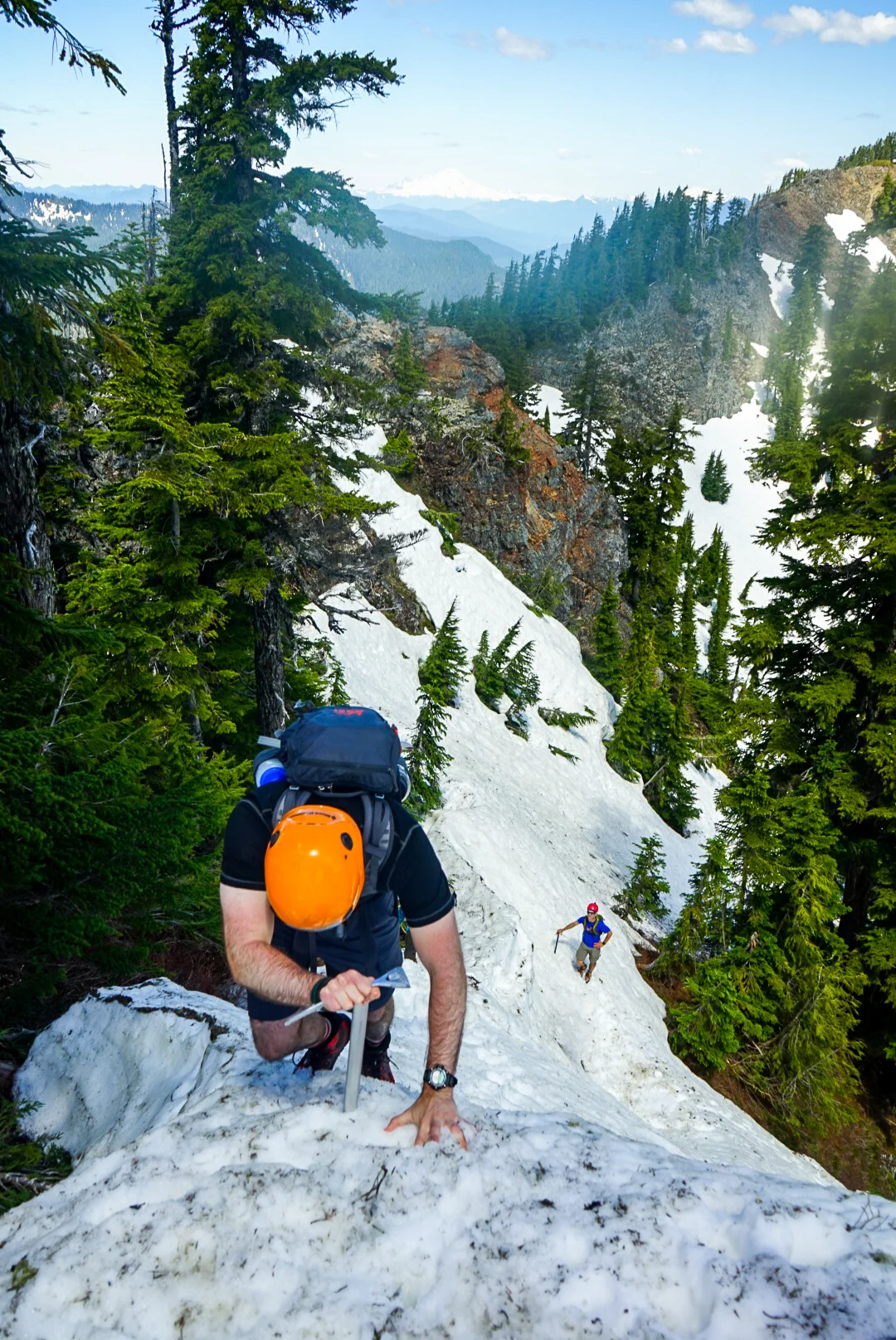 Self-belay with an ice axe down steep snow