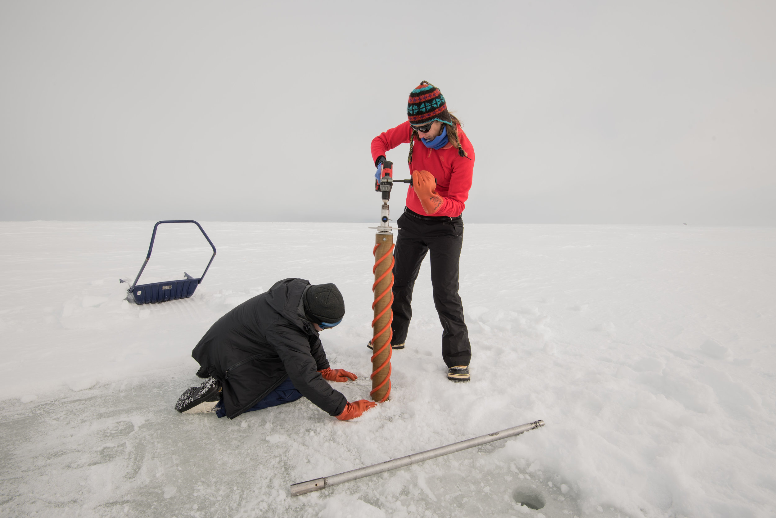 Jodi Young and Hannah Dawson drilling through some sea ice. Photo credit: A. Torstensson