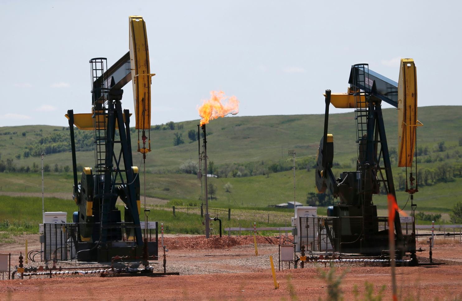 Natural gas burn off near oil pumps in Watford City, N.D. (Charles Rex Arbogast/AP)
