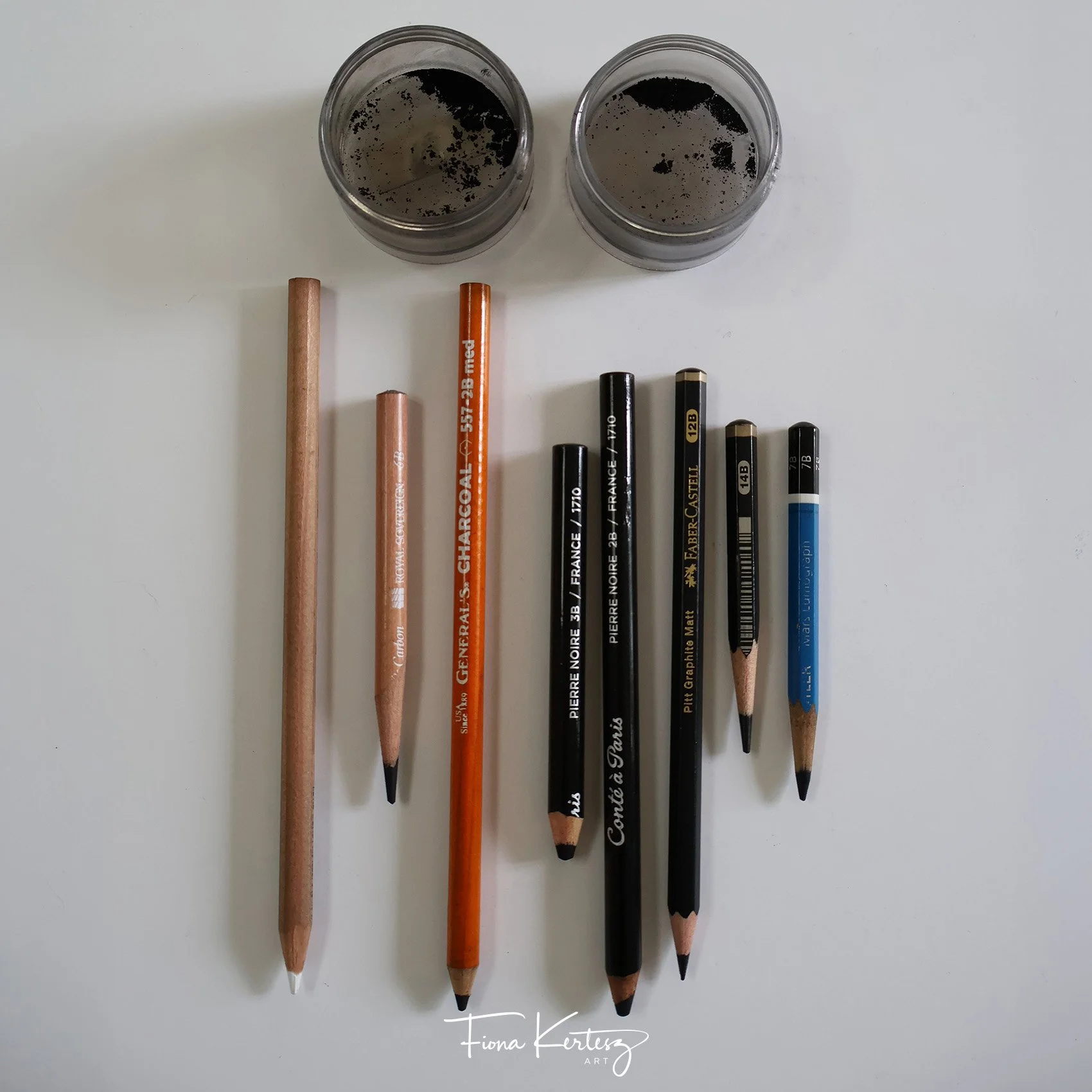 Charcoal tools used in charcoal drawings, charcoal powder, pencils and matt graphite pencils.