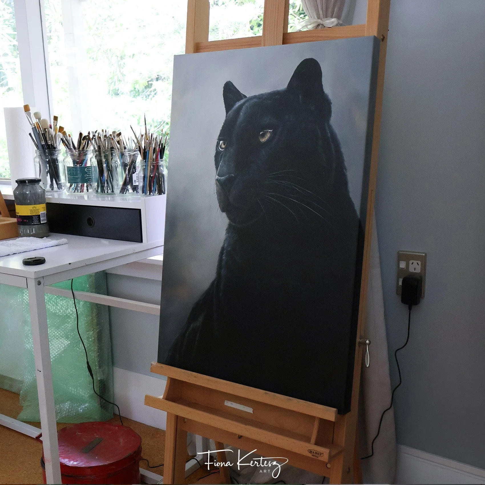 Fiona Kertesz Art large pet portrait and wildlife easel with my panther painting on it