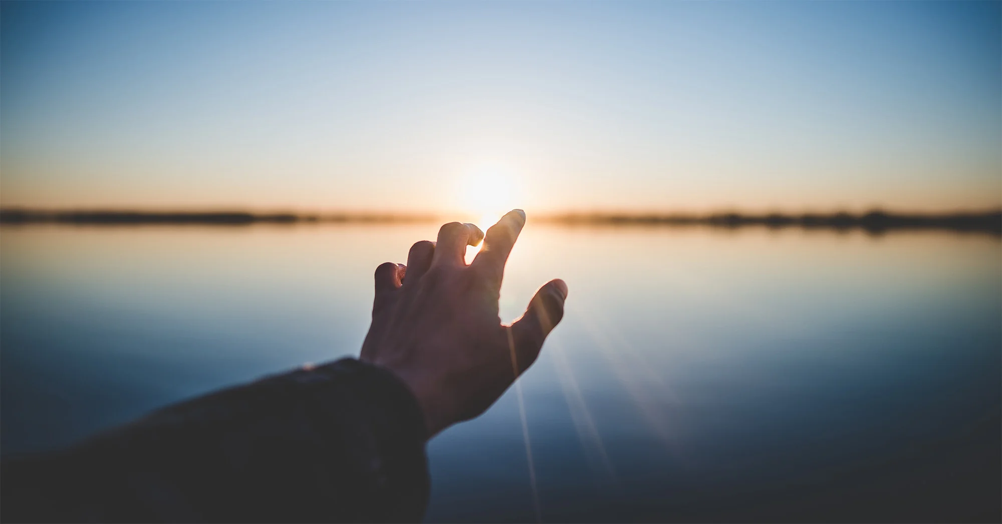 letting-go-of-the-past-hand-reaching-sun.jpg
