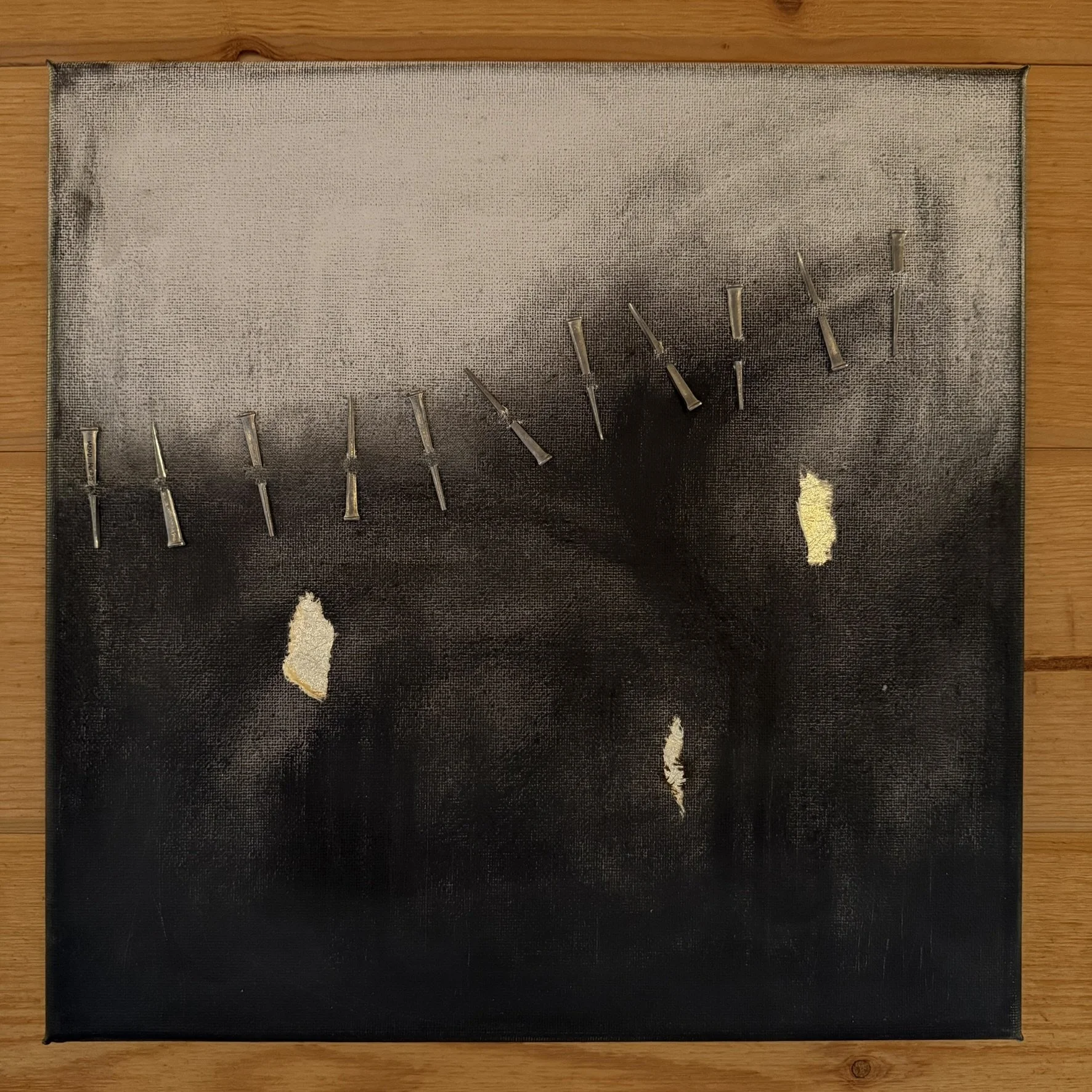  23kt gold leaf, metal nails, paper on canvas  12×12 2025   In winter storms I mend the seams that stretch across the sky.  