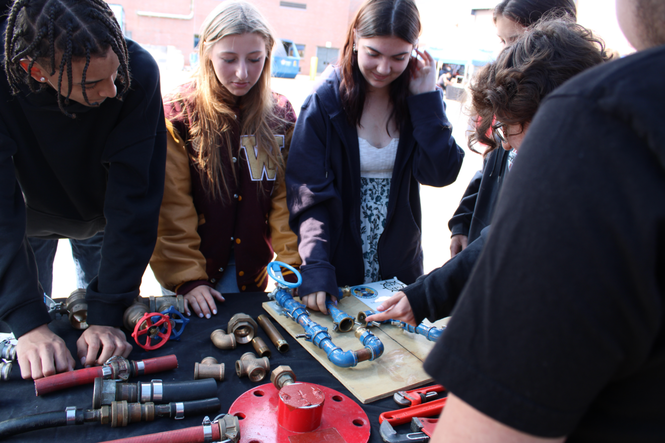 CAD program junior Isaias George, and sophomores Ainsley Rousseau and Serena Finno participate in the Shipyard STEM event.