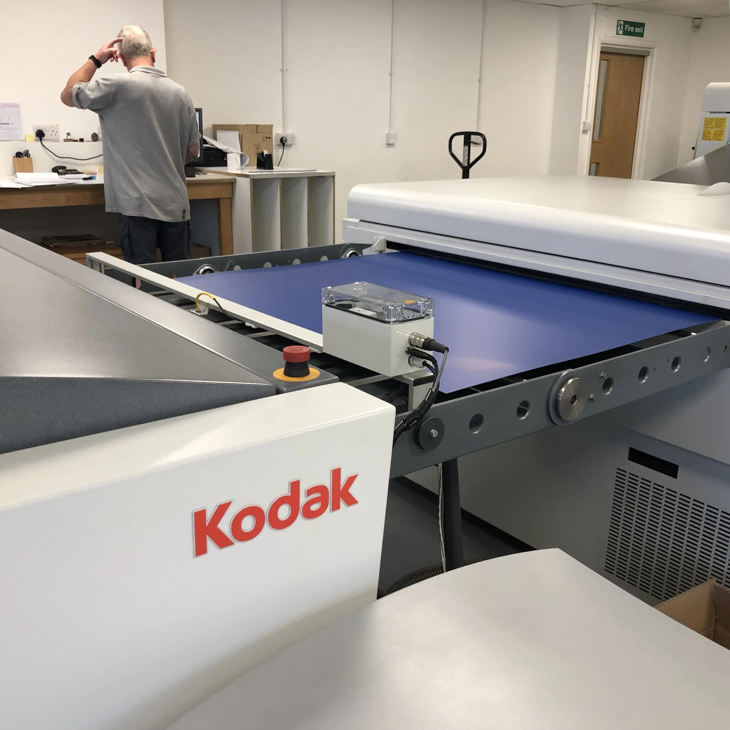 A blue coated plate is fed into the off-set litho machine to be etched. At this stage everything is automated.
