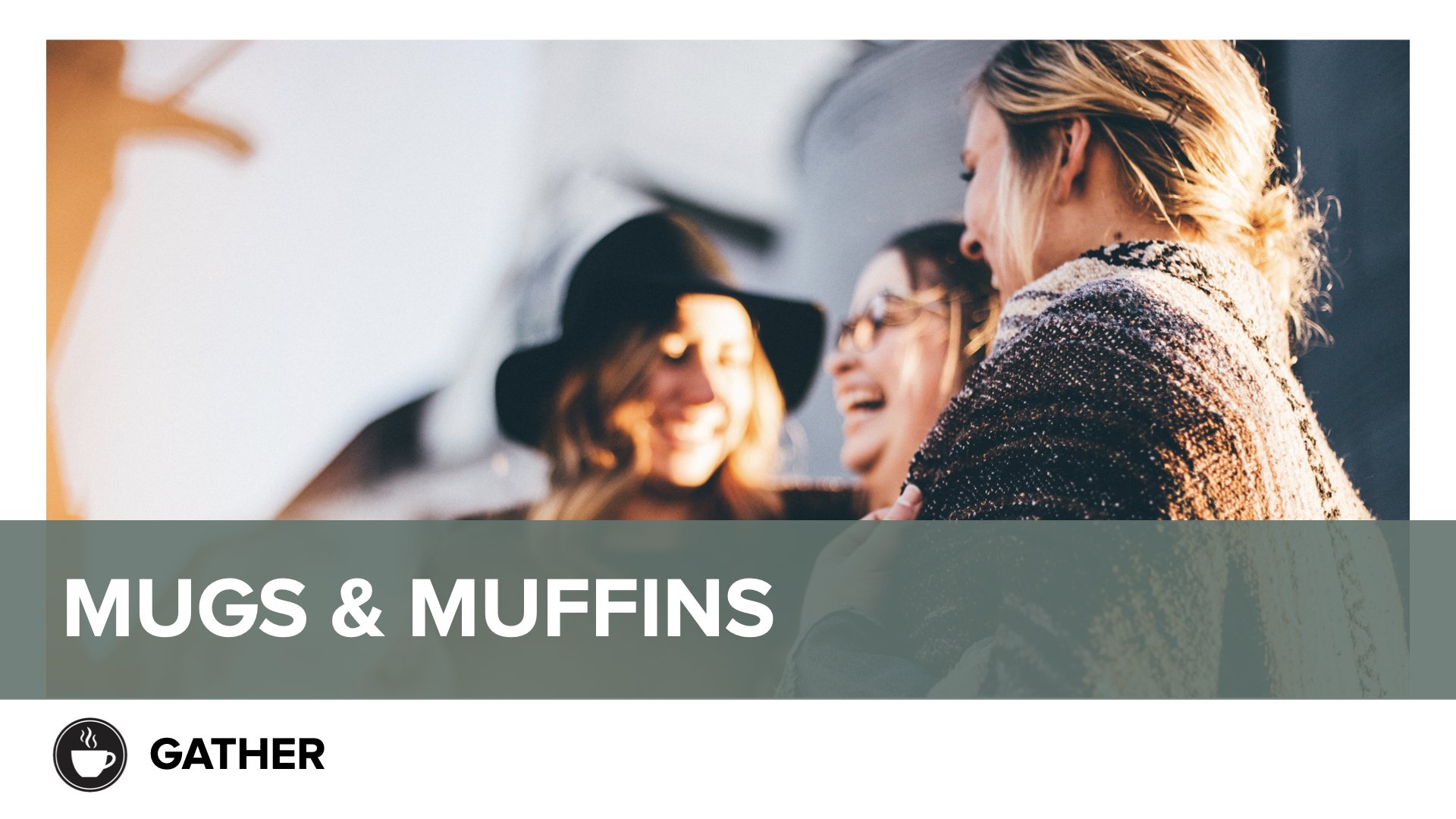 Three friends laughing and talking outdoors during the daytime.