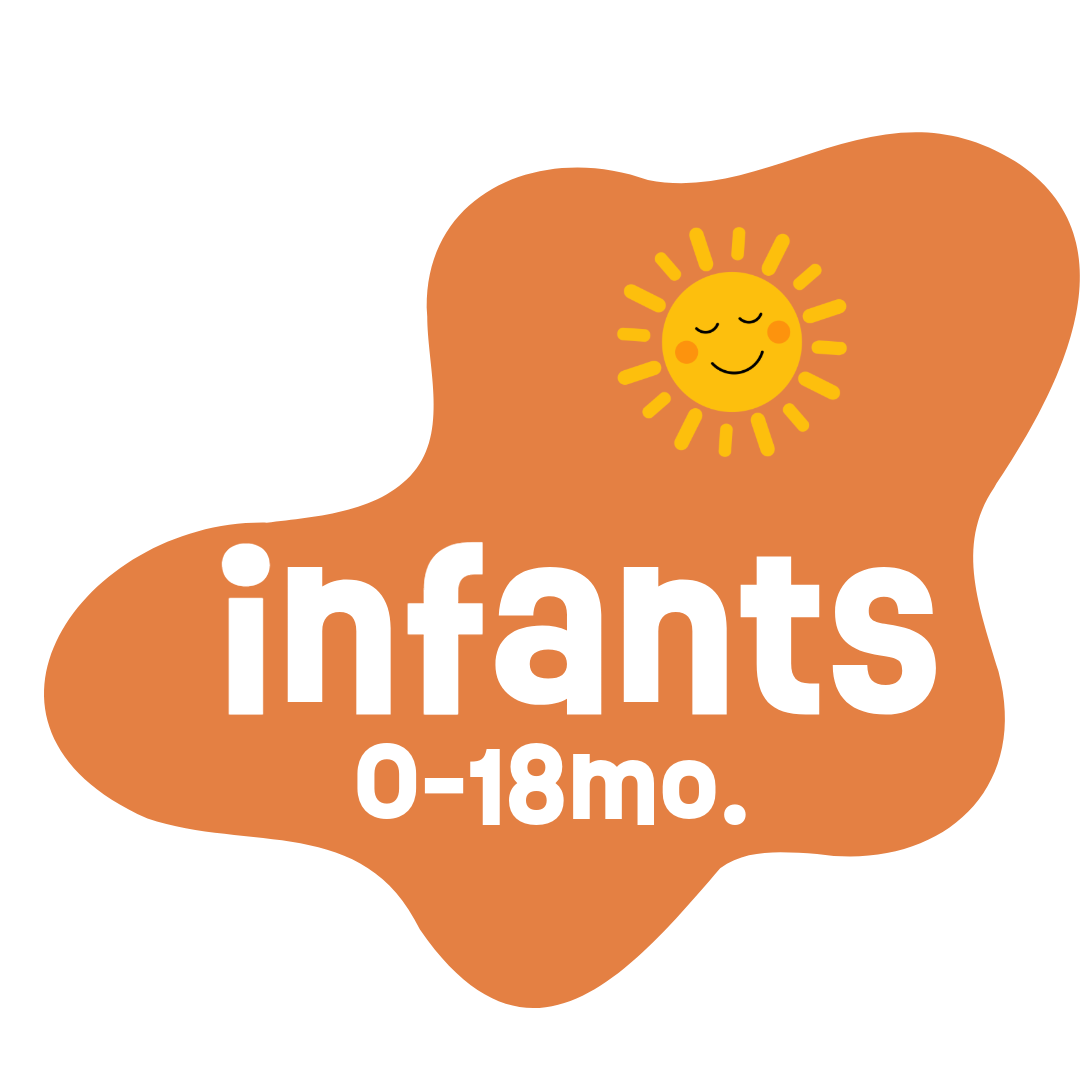 Close-up of a smiling baby with big blue eyes, wearing a pink shirt, lying down on a soft surface.