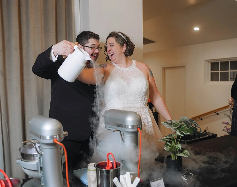 A happy couple at their wedding reception preparing dry ice for a celebration.