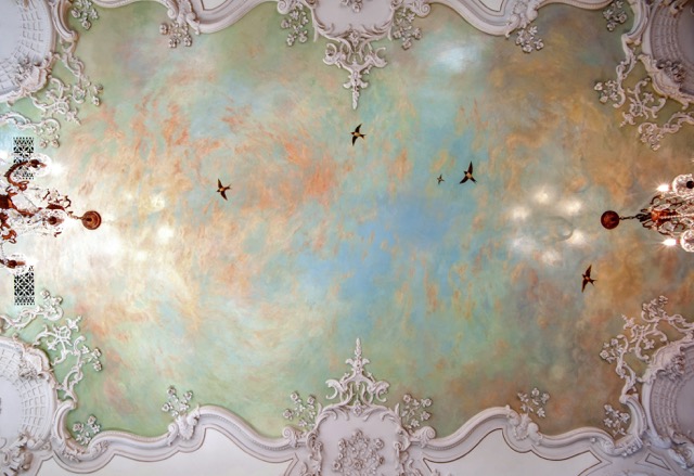 a ceiling mural transports you to another land