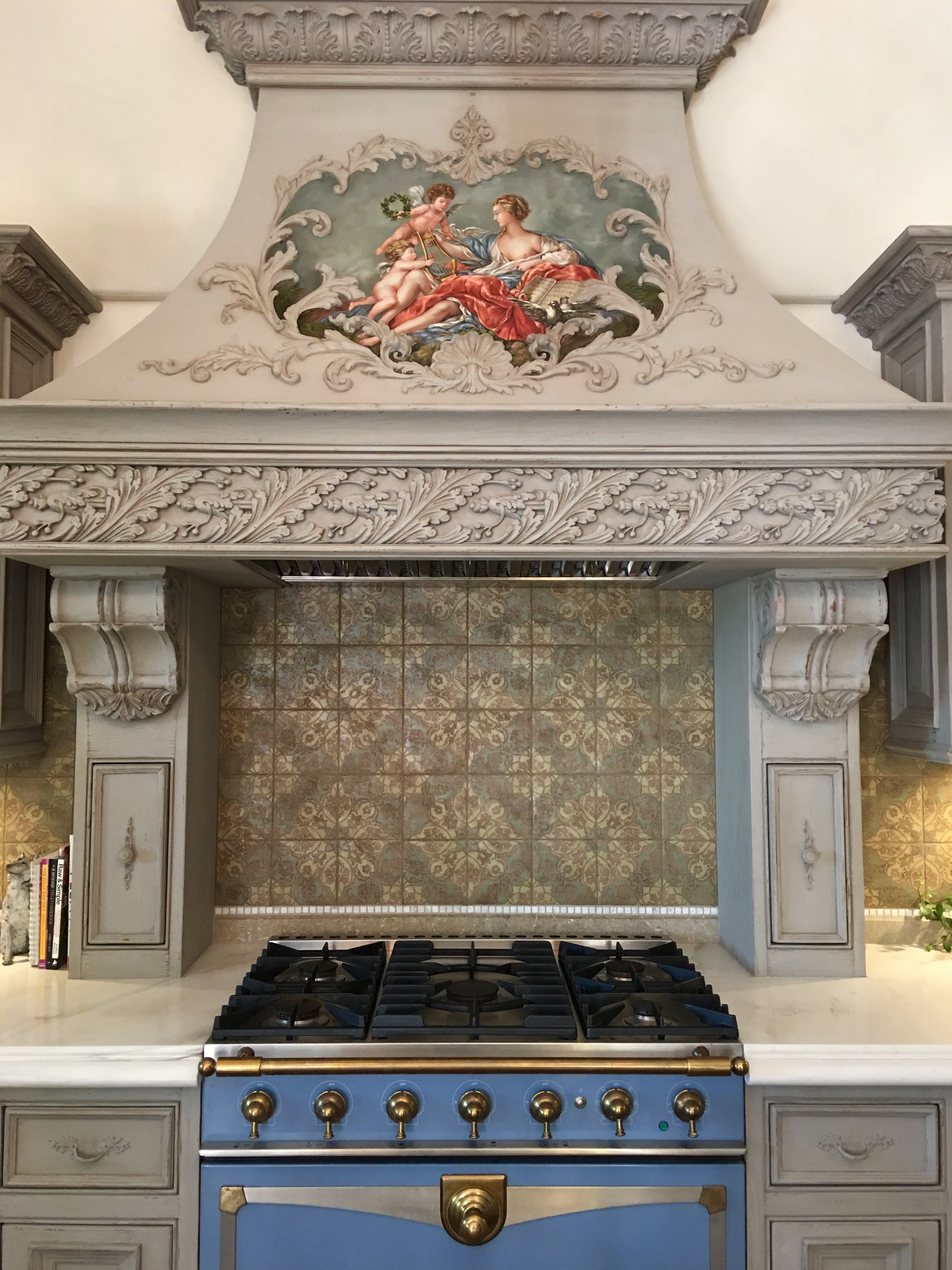 Oven hood adorned with a mural