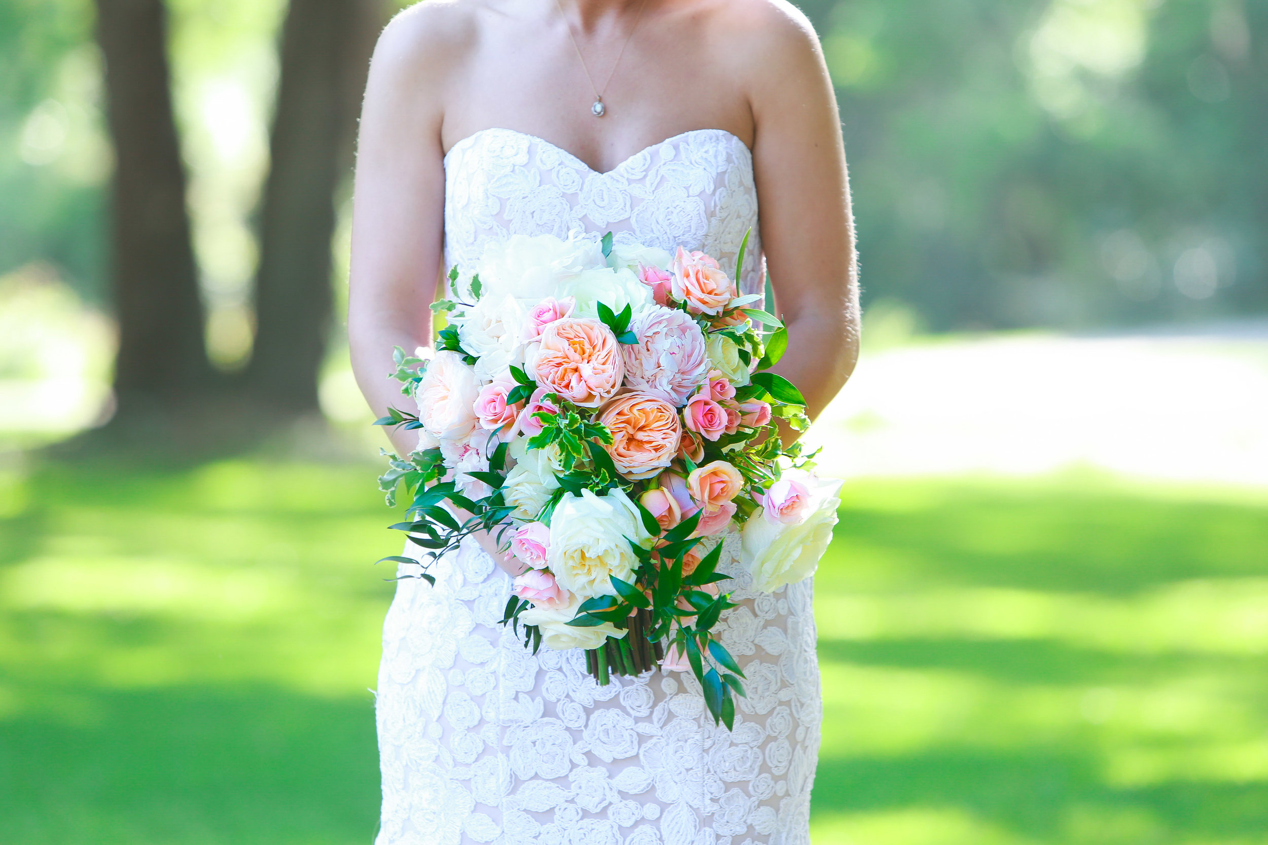  Beautiful pink and white rose bouquet being held by a bride 