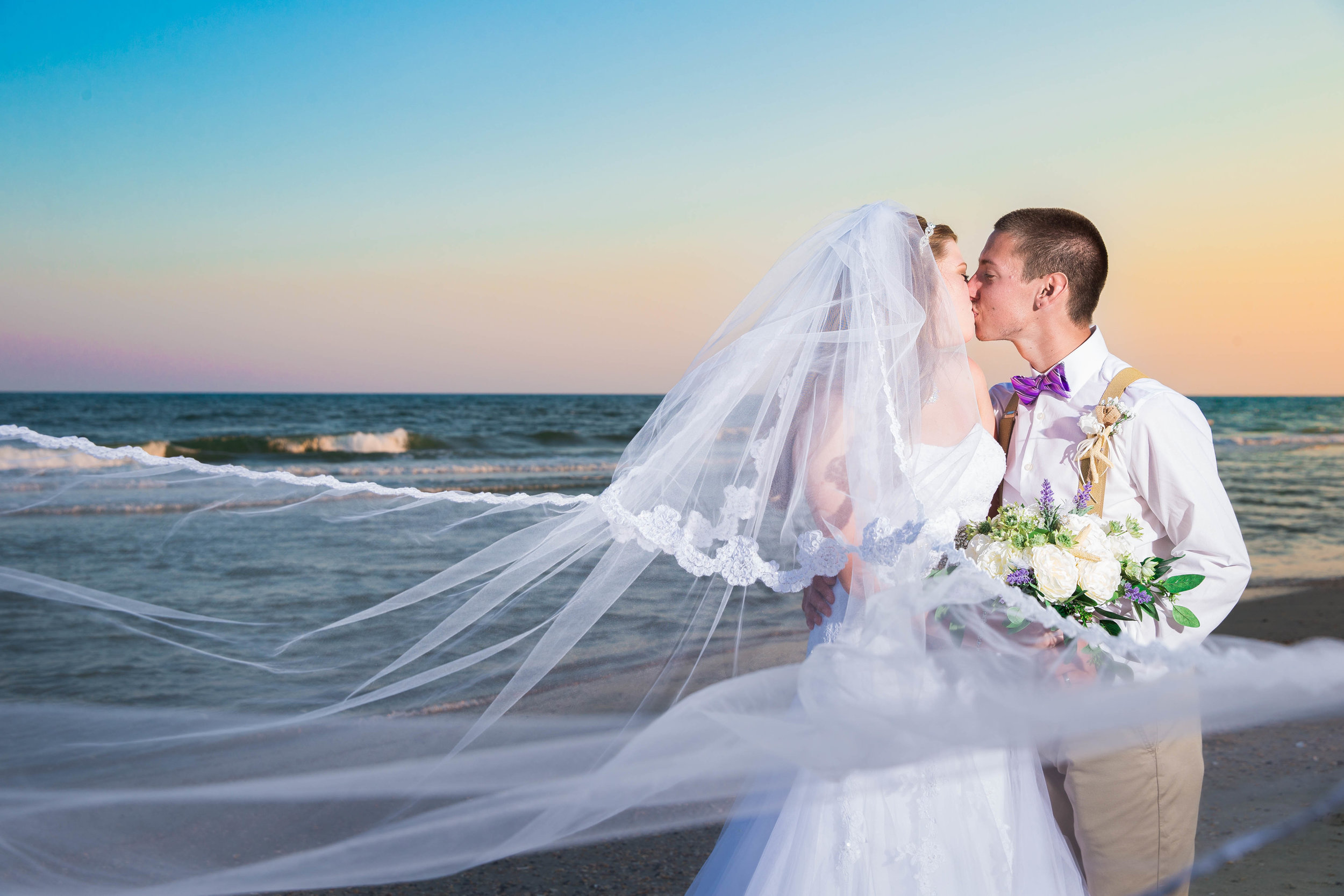  Couple kissing on Myrtle Beach in their wedding attire. 