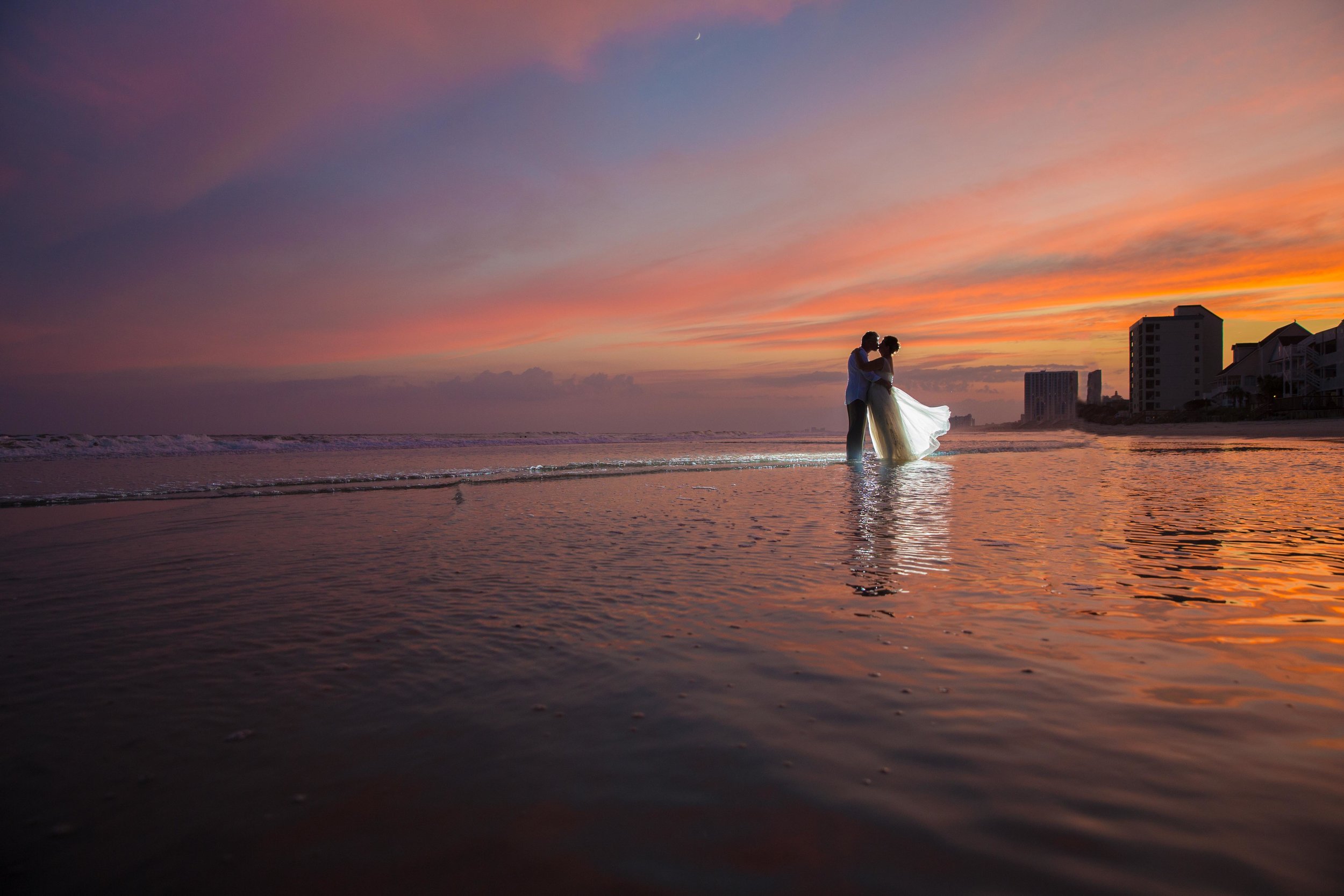  Gorgeous sunset portrait of a newlywed couple on the beach 