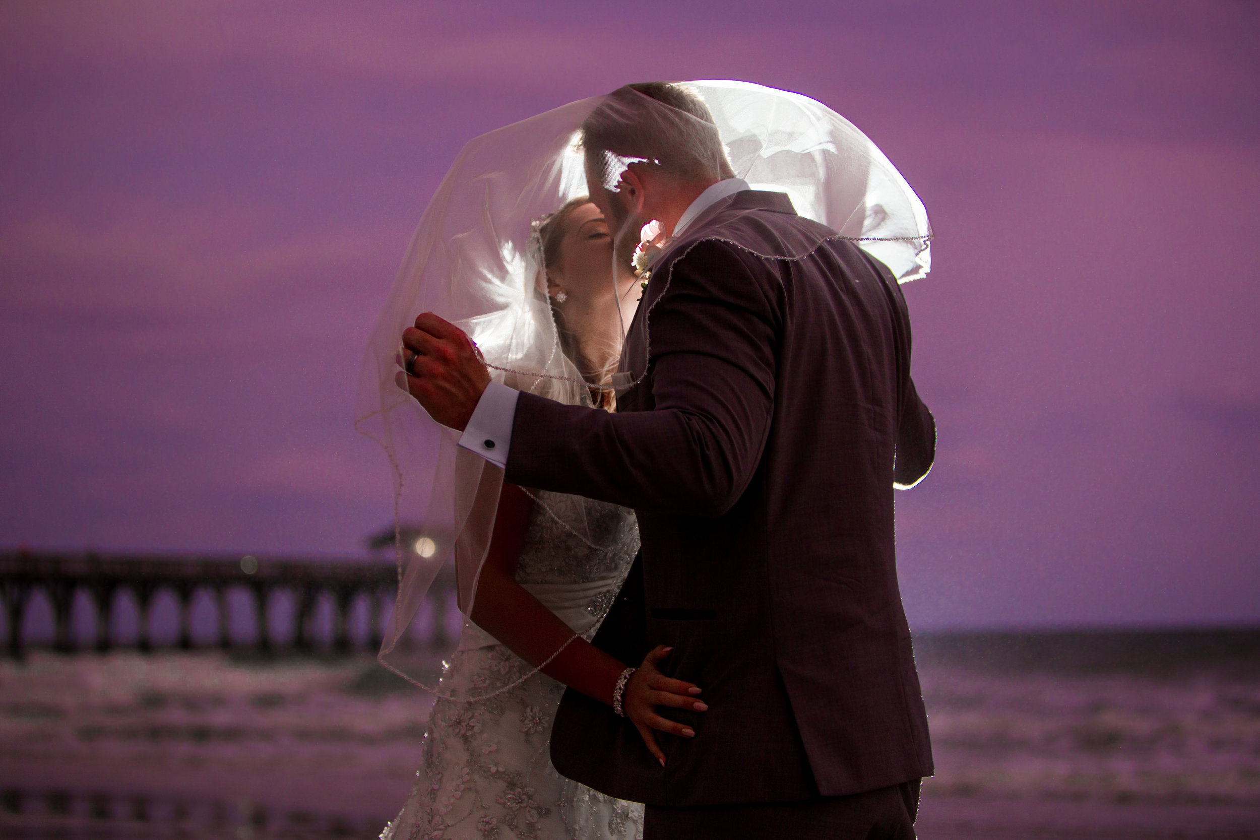  Newlyweds kissing at twilight on the beautiful Myrtle Beach shore 