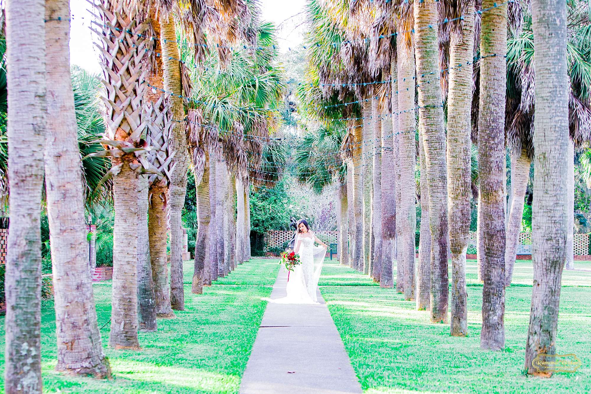 bride in wedding dress walking on path of palm trees at brookgreen gardens during bridal session with ramona nicolae photography at brookgreen gardens -5.jpg