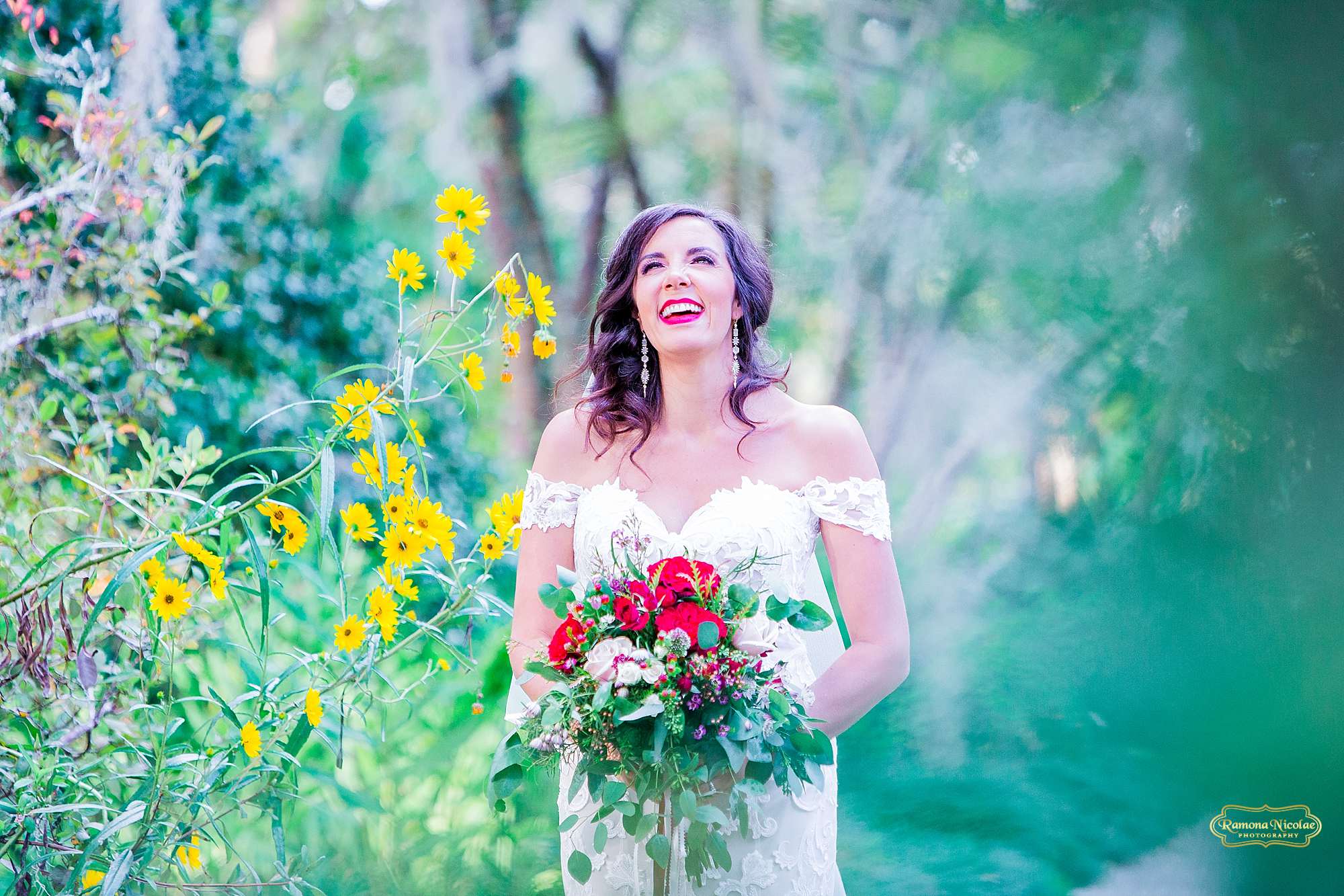 bride smiling surounded by flowers at brookgreen gardens for her bridal session with ramona nicolae photography in myrtle beach sc-3.jpg