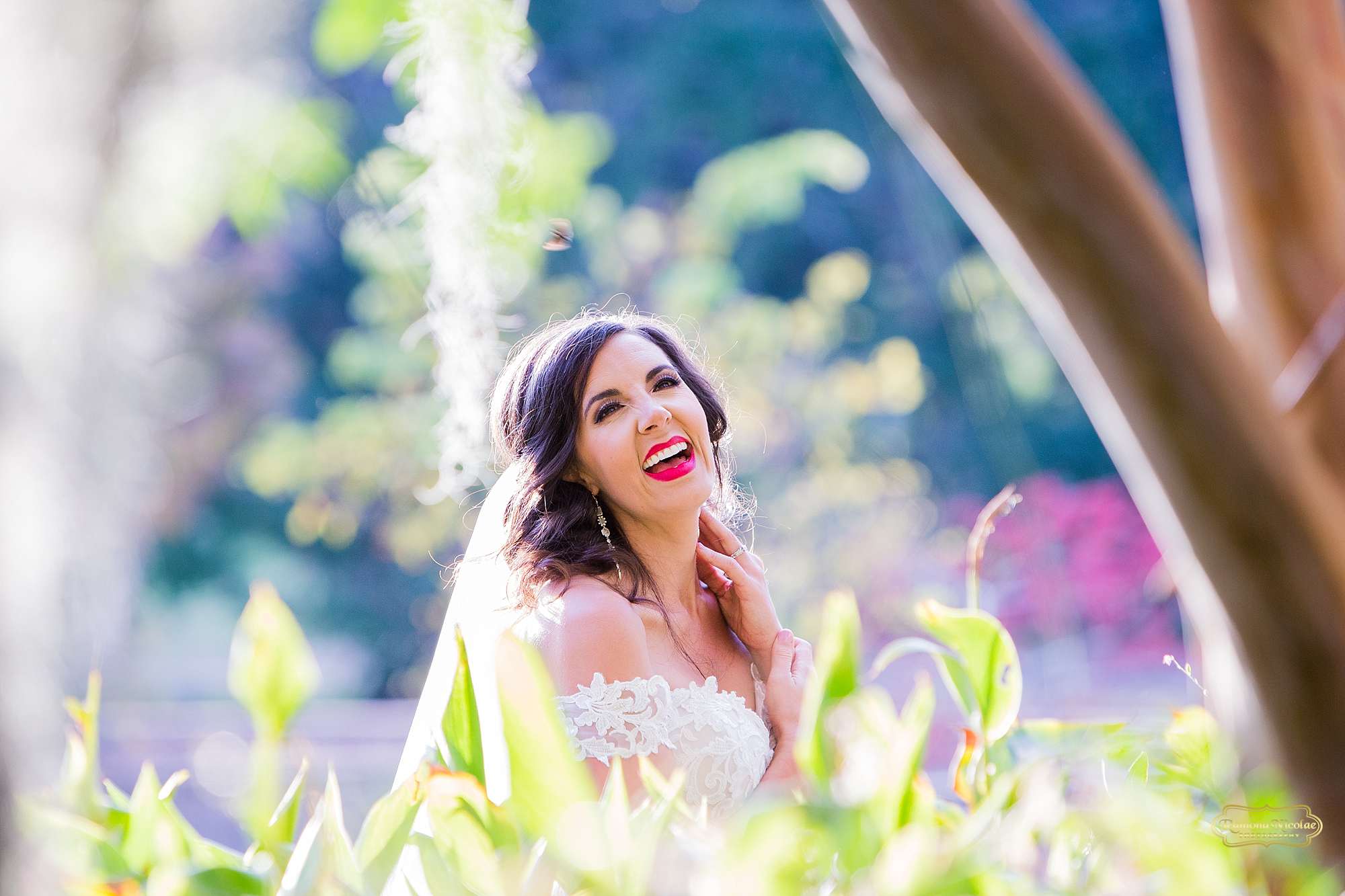 stunning bride between greenery with red lipstick at brookgreen gardens by ramona nicolae photography best myrtle beach photographer-4.jpg