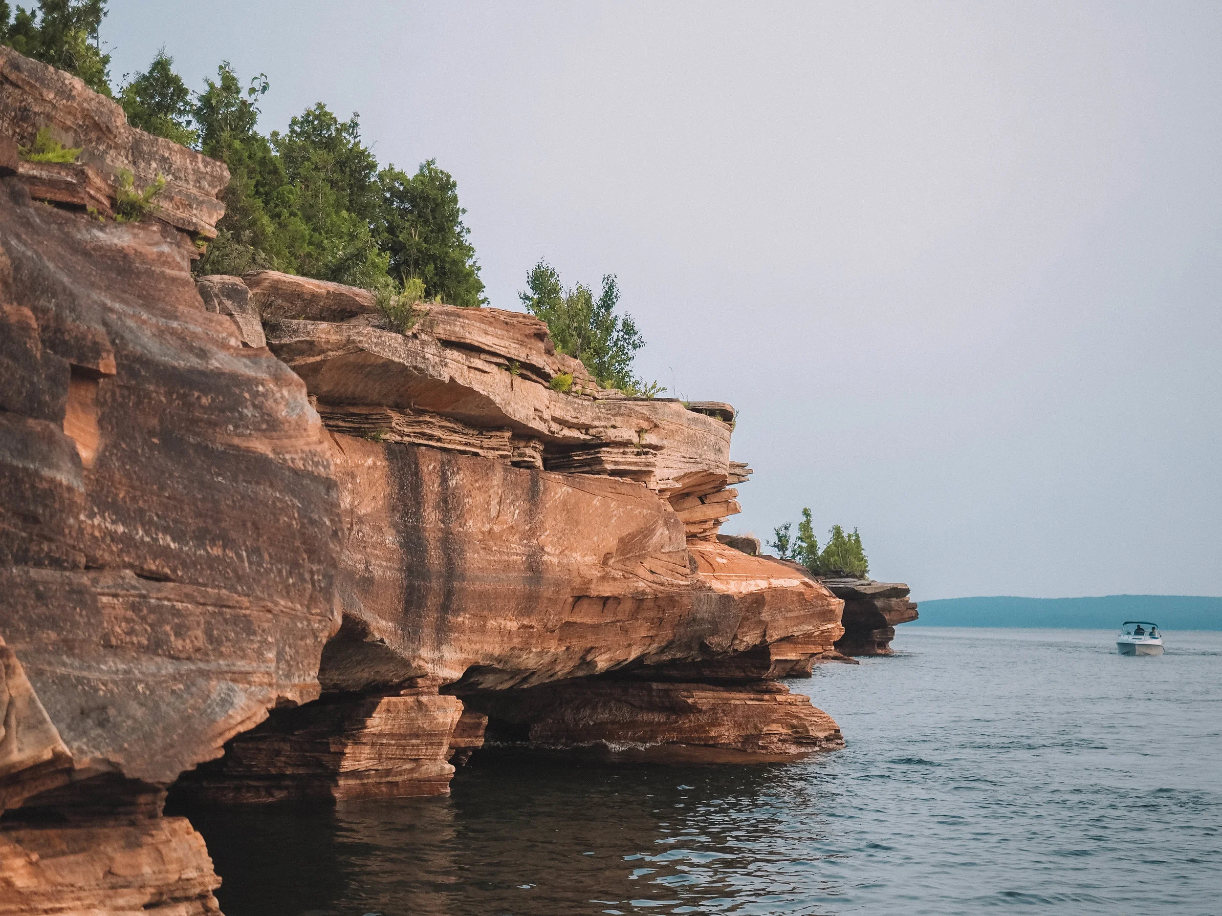 Spend your day sailing the Apostle Islands National Lakeshore in northern Wisconsin. A boat charter will give you access to hiking trails, kayaking routes and the gorgeous Apostle Islands sea caves. #apostleislands #wisconsin #lakesuperior #sailing
