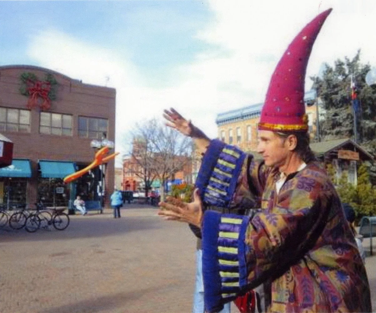 Matt in a wizard outfit, catching a boomerang, Old Town Square, Fort Collins, Colorado
