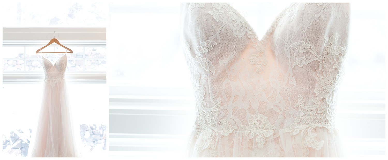 lace detailing on a wedding dress hanging in a window