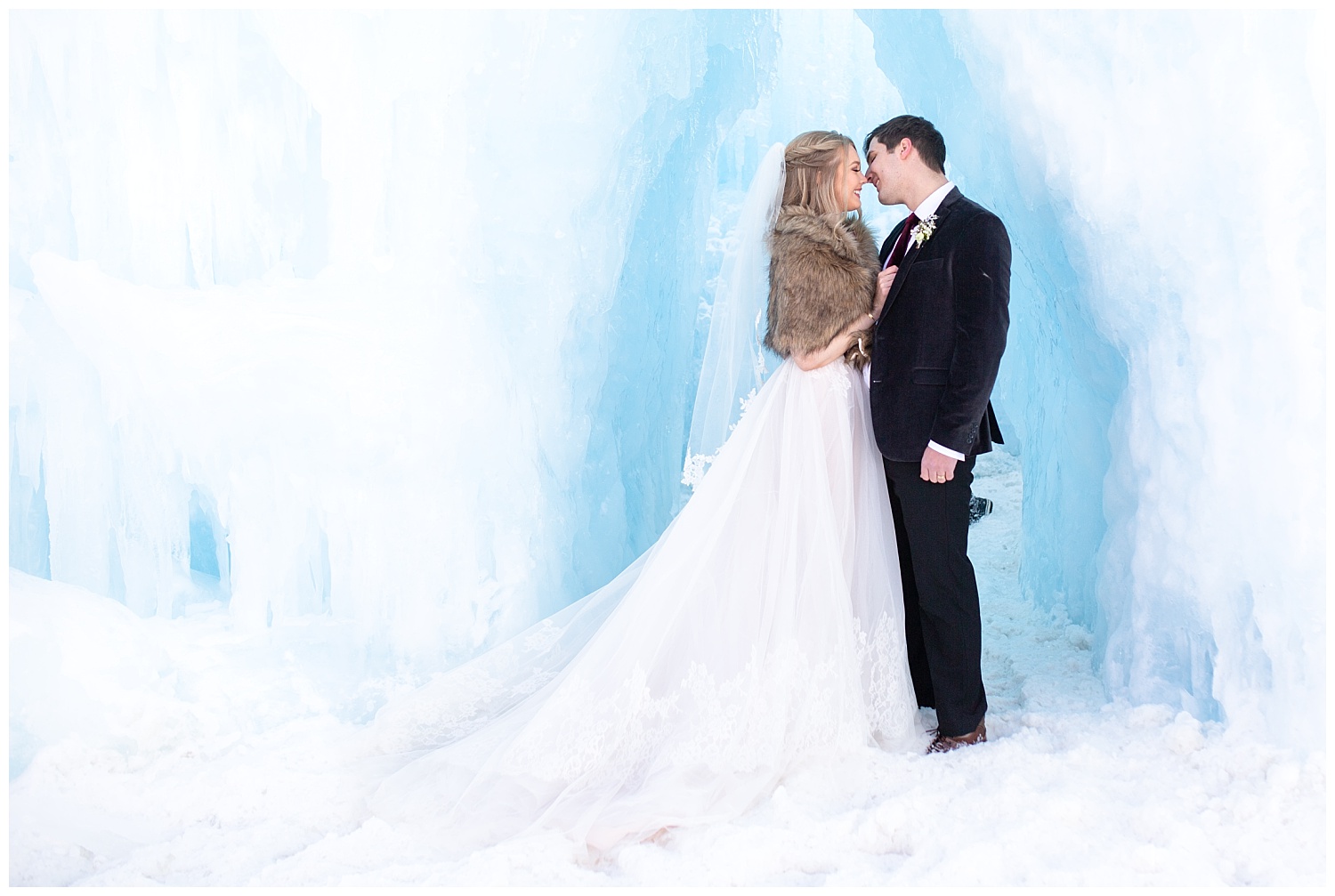 a bride and groom almost share a kiss underneath a beautiful ice sculpture