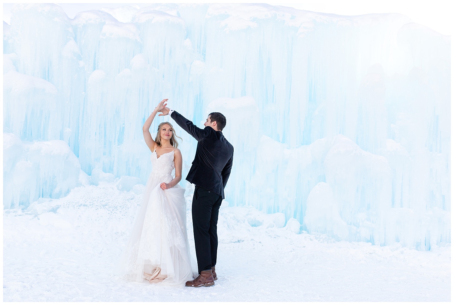 A groom spins his beautiful bride at the Ice Castles in Dillon, Colorado