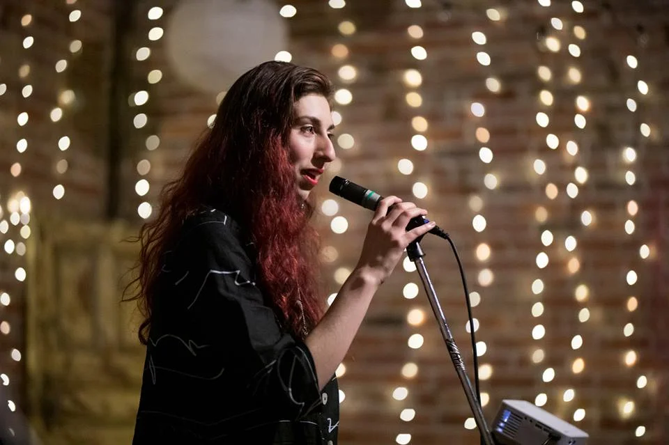 All Around Artsy Owner/Director Kira Bursky speaking at the All Around Artsy Music Video Premiere Party.