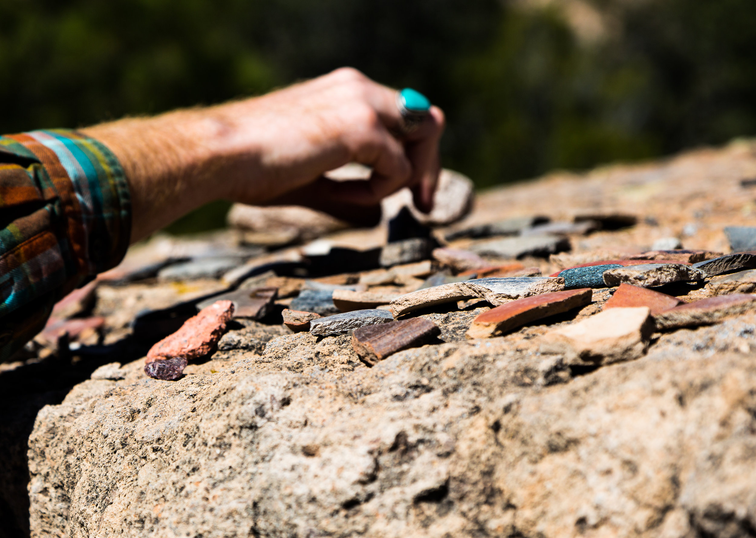 They encourage all guests to look at, pick up, and examine these artifacts. In their experience, making these piles easily accessible results in less artifact theft.
