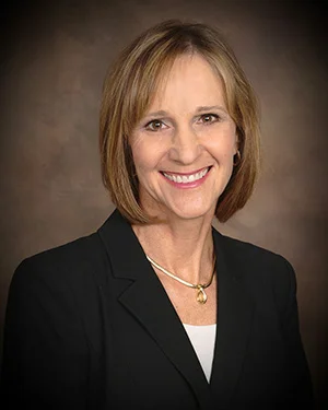 Picture of woman with blonde hair in business professional clothing.