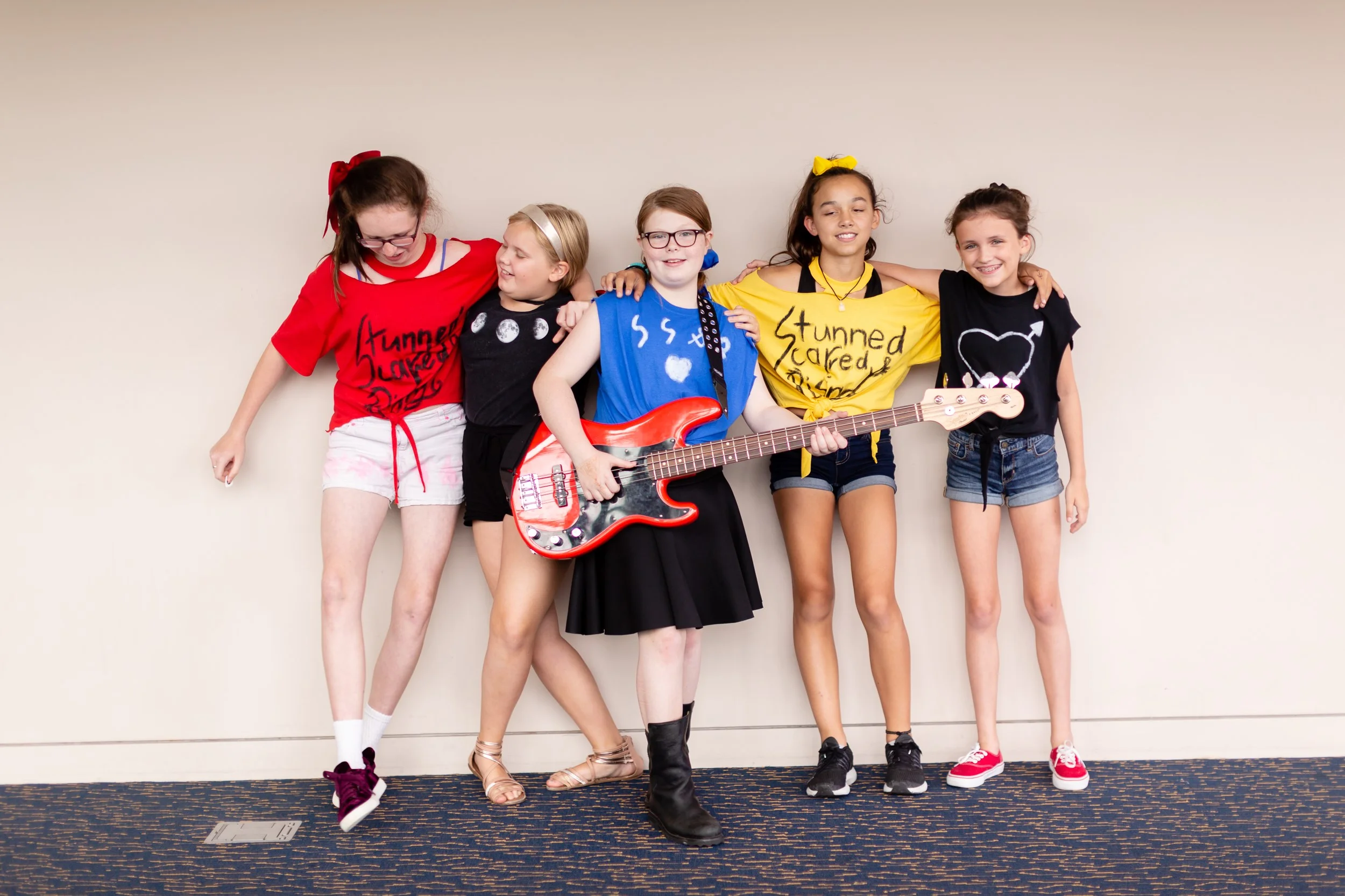 A band of campers that formed during the 2018 summer camp with some rad band tees.