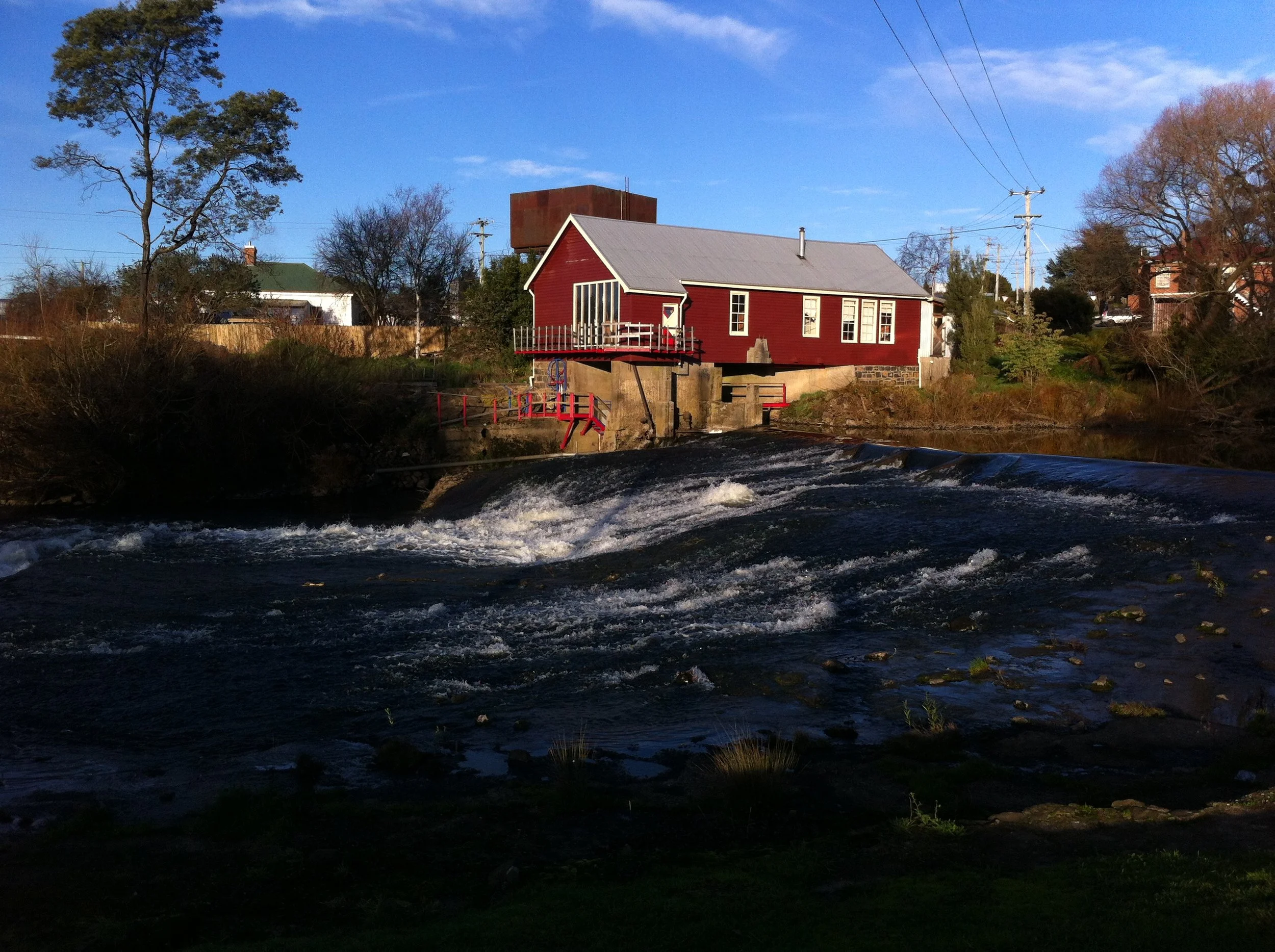 Long shot across river to power house with rough water.JPG