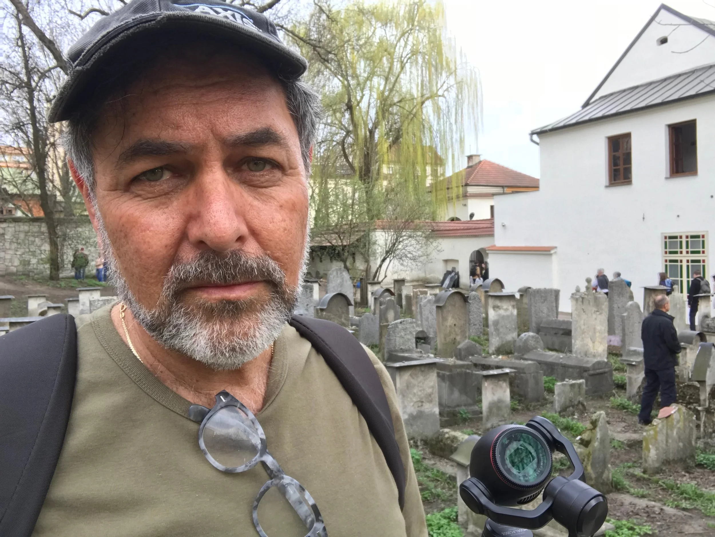 Jerry Levine on location filming in Poland - the Remah Synagogue can be seen behind him. During World War II Krakow's buildings and landmarks escaped mostly unscathed. Its preservation makes it a key destination for Holocaust Survivors, students and Jewish missions, such as this one organized by the Greater Miami Jewish Federation.