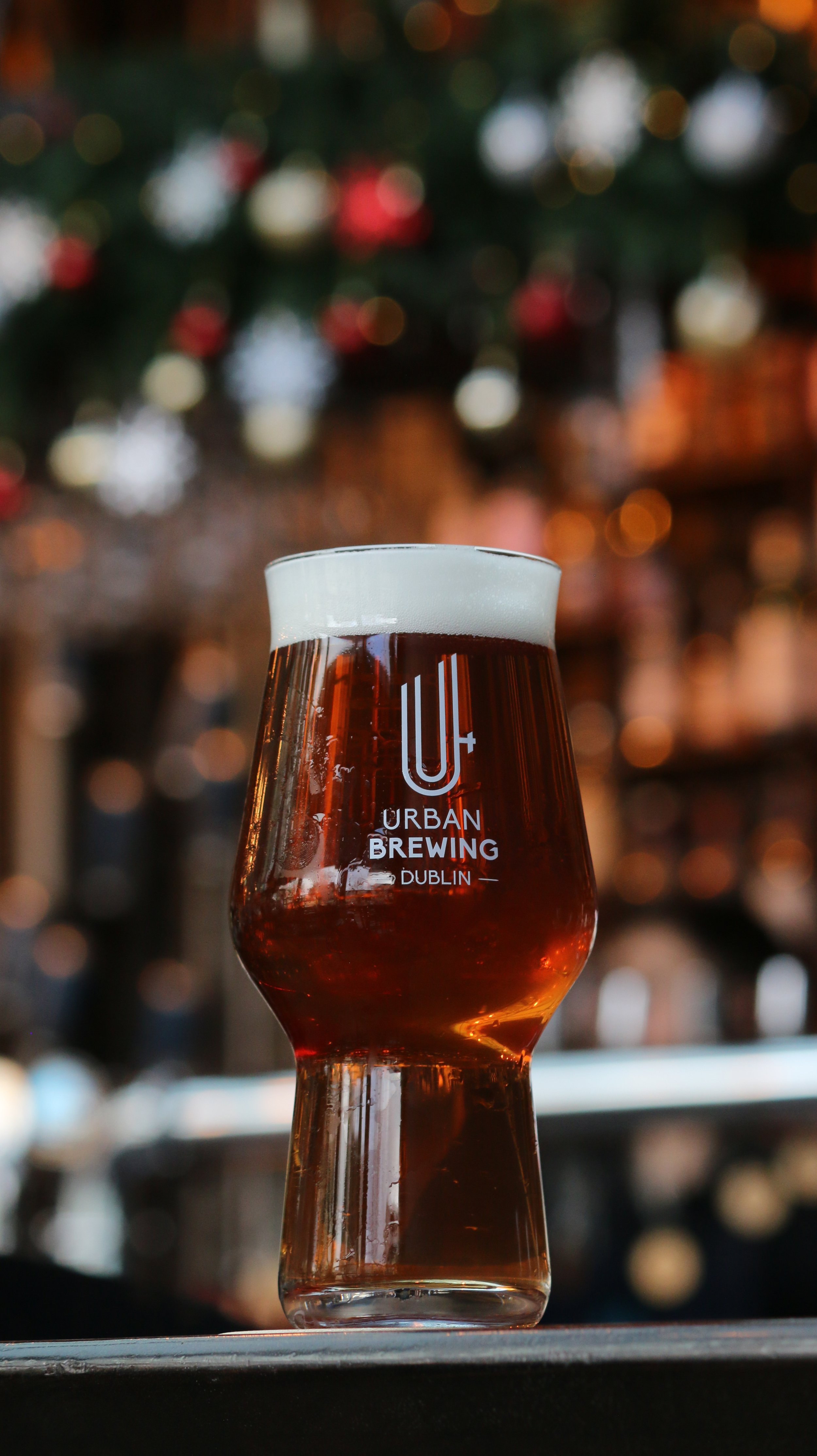 Urban Brewing house-brewed beer served in a branded glass at the Dublin brewery