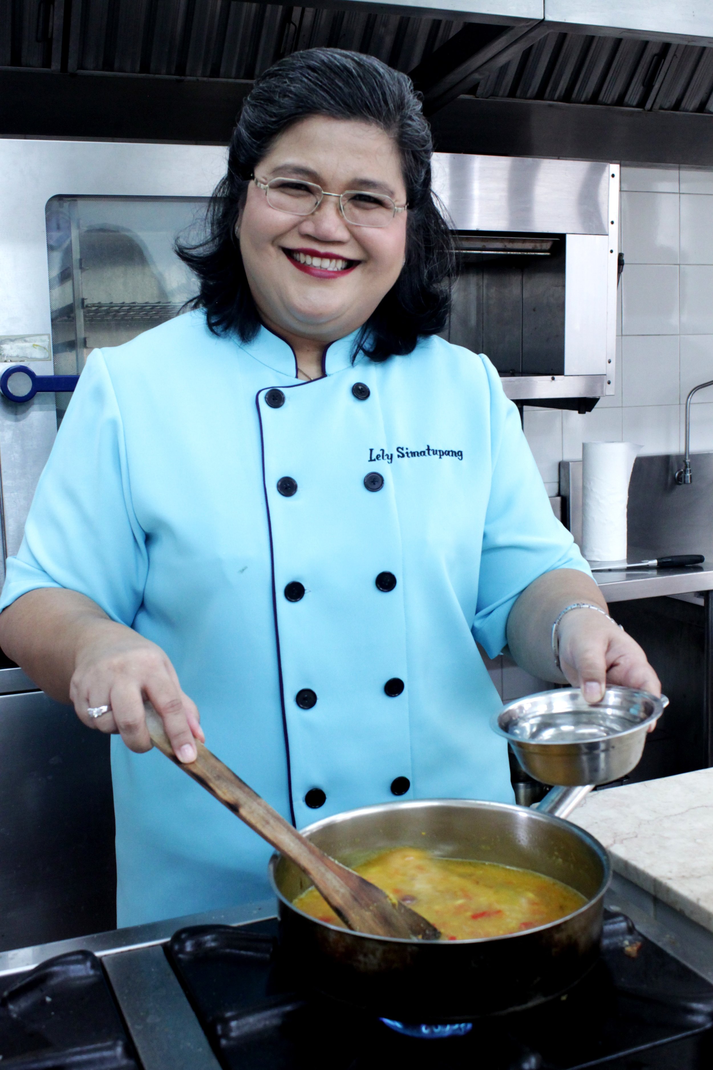  Portrait of cancer survivor and cooking extraordinaire Chef Lely Simatupang in the kitchen of her cooking school. Photo by Natasha Ishak. 